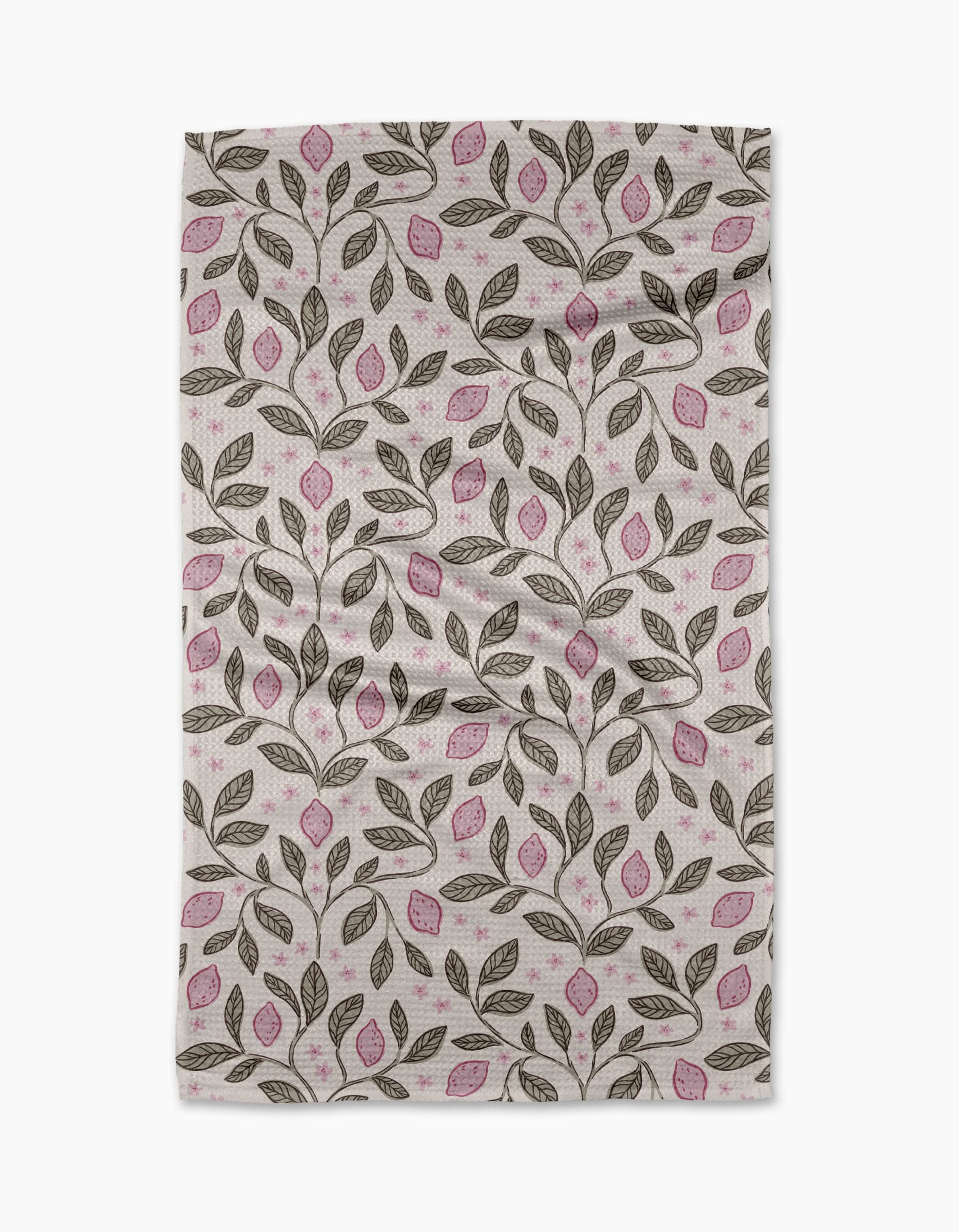 The Pink Summer Lemons tea towel by Teri the Butter features a repeating pattern of brown branches, pink-accented leaves, and a white background. Slightly wrinkled, it’s ultra-absorbent—ideal for everyday use.