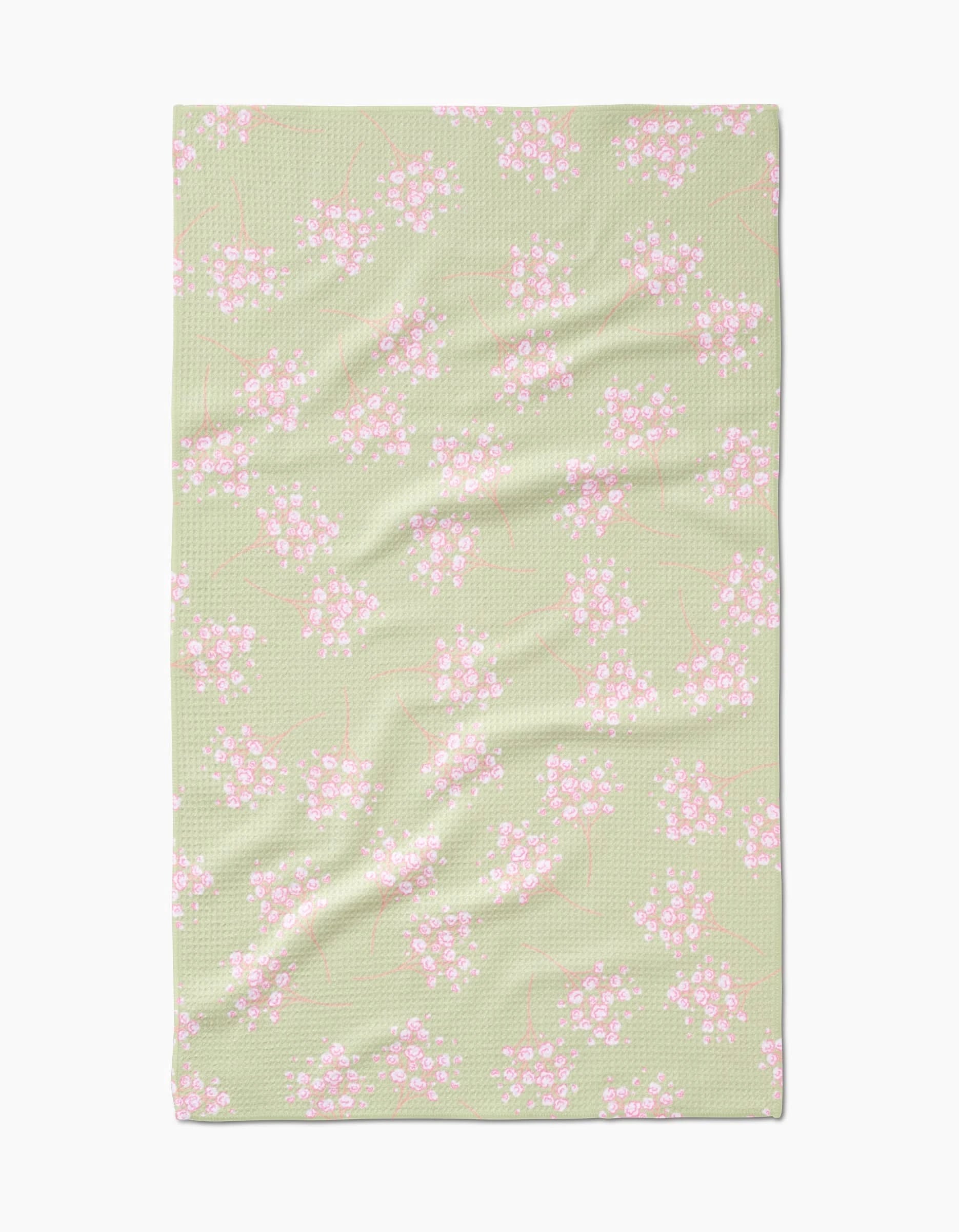 The Pocket of Posies by Sarah Reed is a light green Geoweave towel featuring a textured surface and an ultra-absorbent design, decorated with small pink and white flowers with green stems evenly scattered across it.