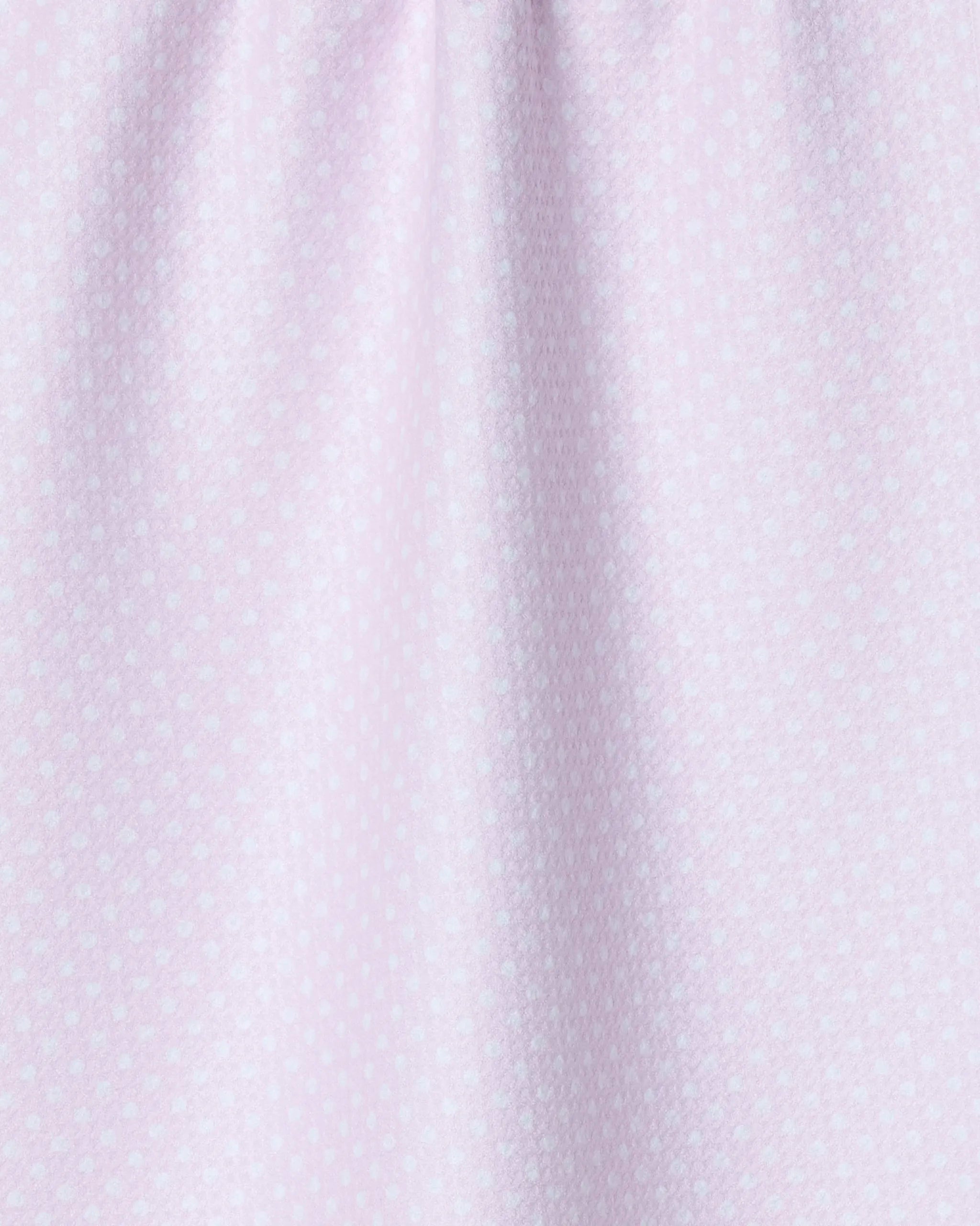 The Geometry Polka Val tea towel features a light pink color with a subtle pattern of small, evenly spaced white dots—perfect for adding style and charm to your kitchen essentials.