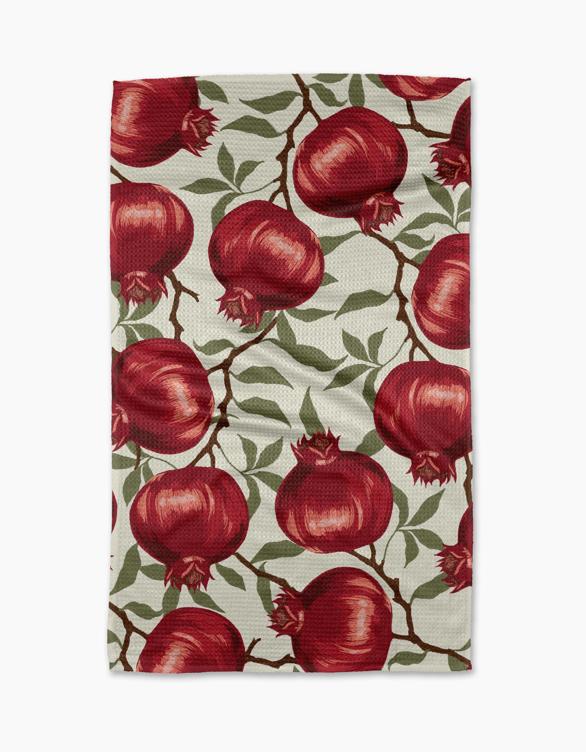 The "Pomegranate Party" tea towel by Ashley Reeves is rectangular, made from recycled materials, and features red pomegranates, green leaves, and brown branches on a light background.