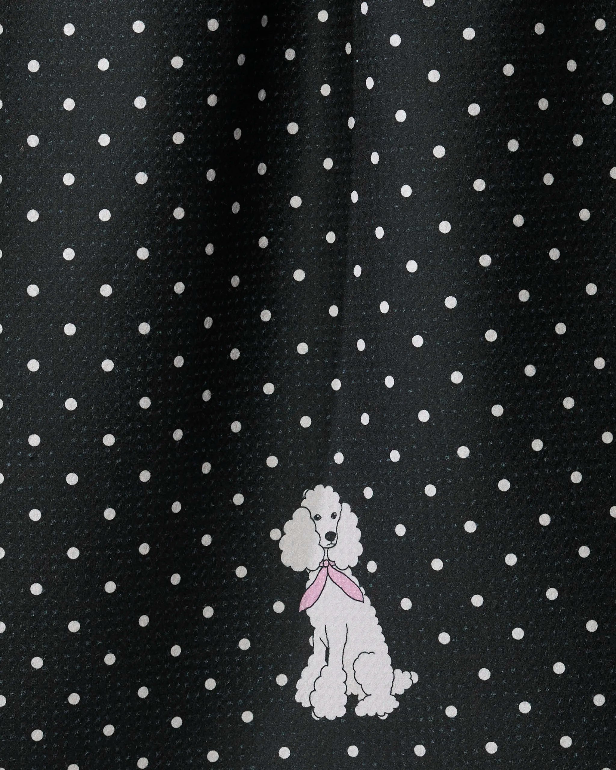 The Geometry Poodle Charm tea towel features black fabric adorned with white polka dots and a delightful illustration of a white poodle wearing a pink scarf near the bottom center. This ultra-absorbent and practical towel brings playful flair to your kitchen decor.