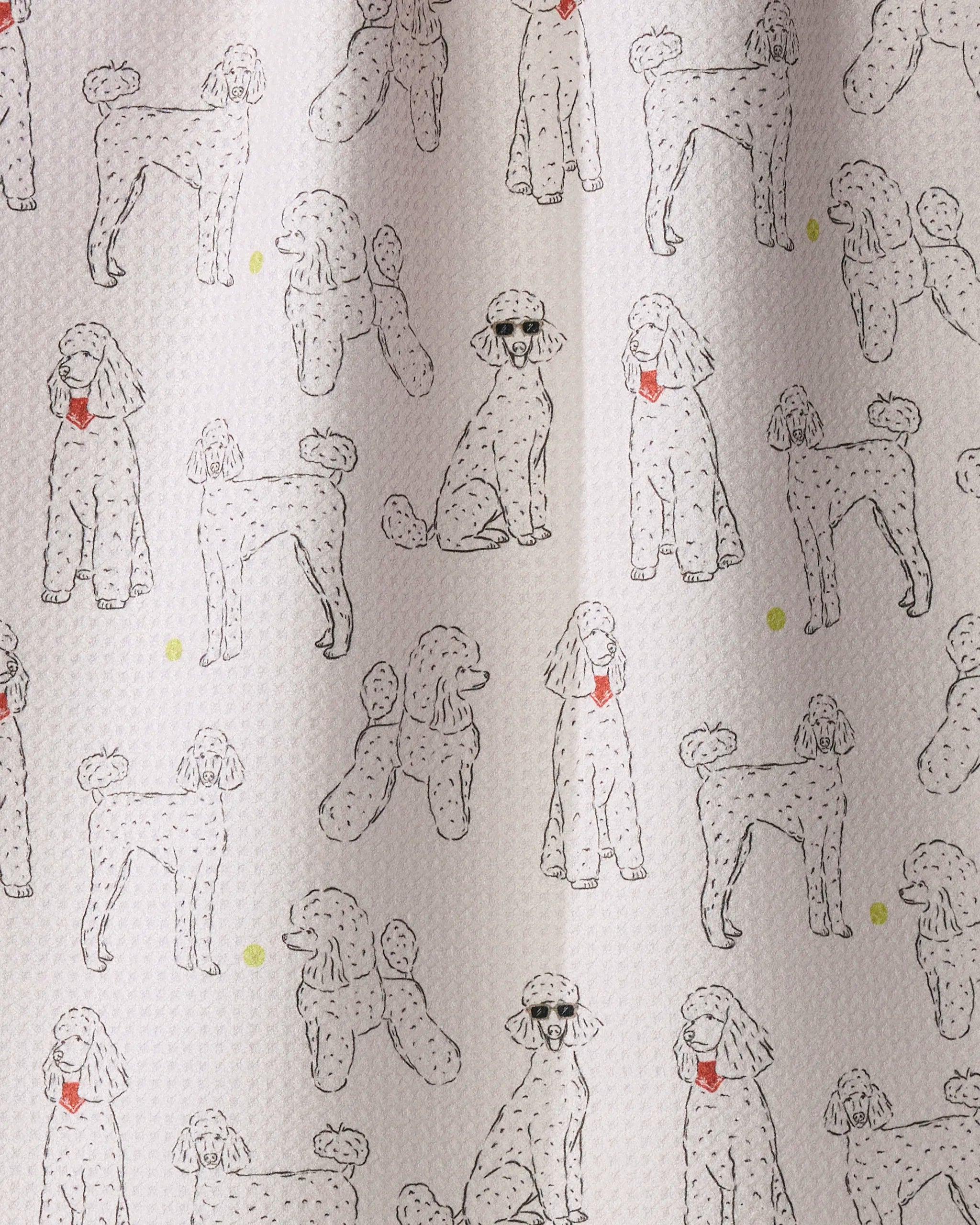 The Geometry Poodle Party tea towel is a patterned kitchen accessory featuring hand-drawn poodles—some sitting, some standing—each wearing a red collar, with cheerful yellow dots scattered throughout. This eco-friendly and absorbent dish towel adds charm to your kitchen décor while being perfect for everyday use.