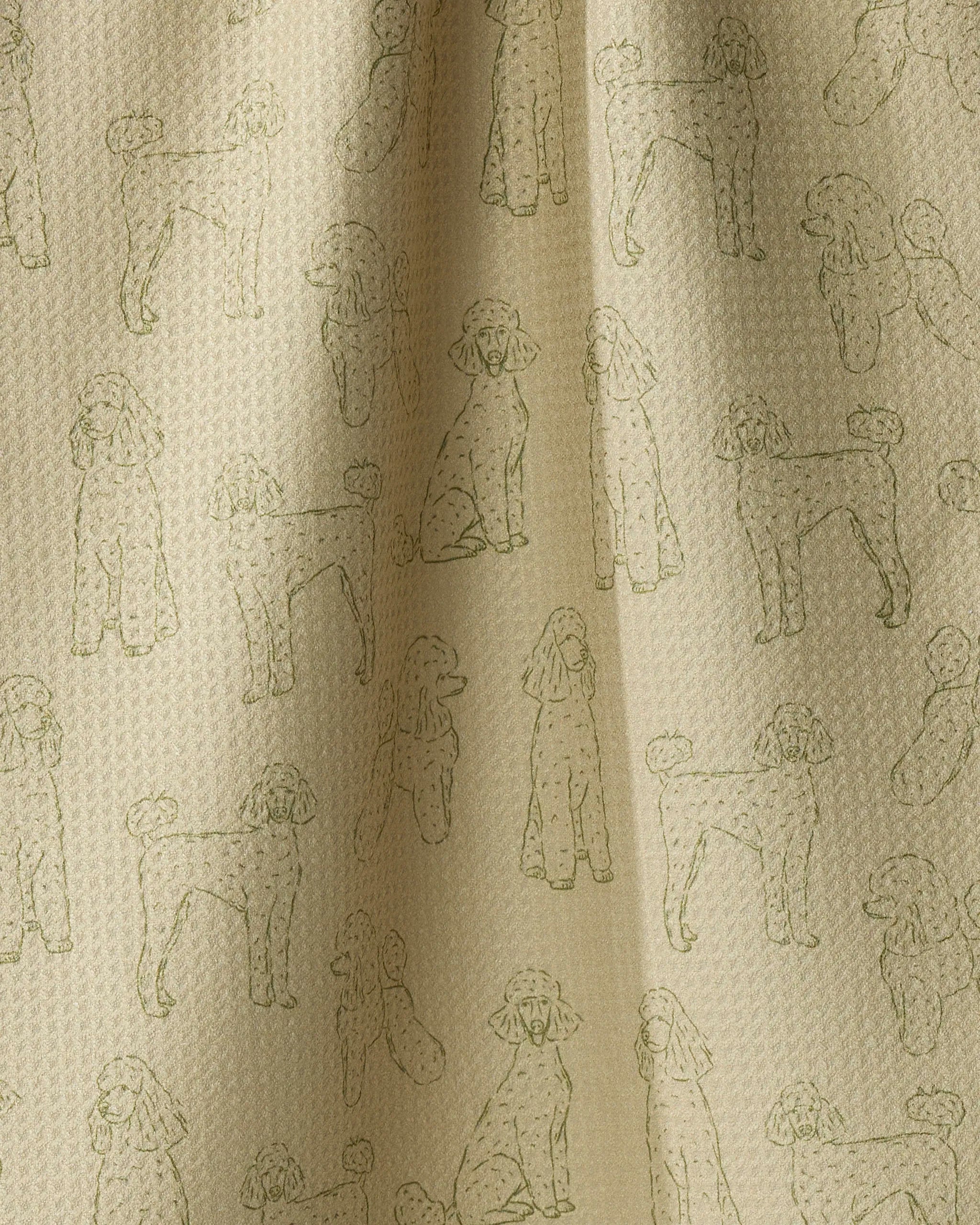 Add a playful touch to your kitchen with the “Poodle Pups” dish towel by Geometry. Crafted from absorbent beige fabric, this charming tea towel features a subtle, embossed pattern of poodles in various poses, repeated throughout. The slightly wavy texture with gentle folds and soft shadowing makes it perfect for drying dishes or displaying as an elegant accent.