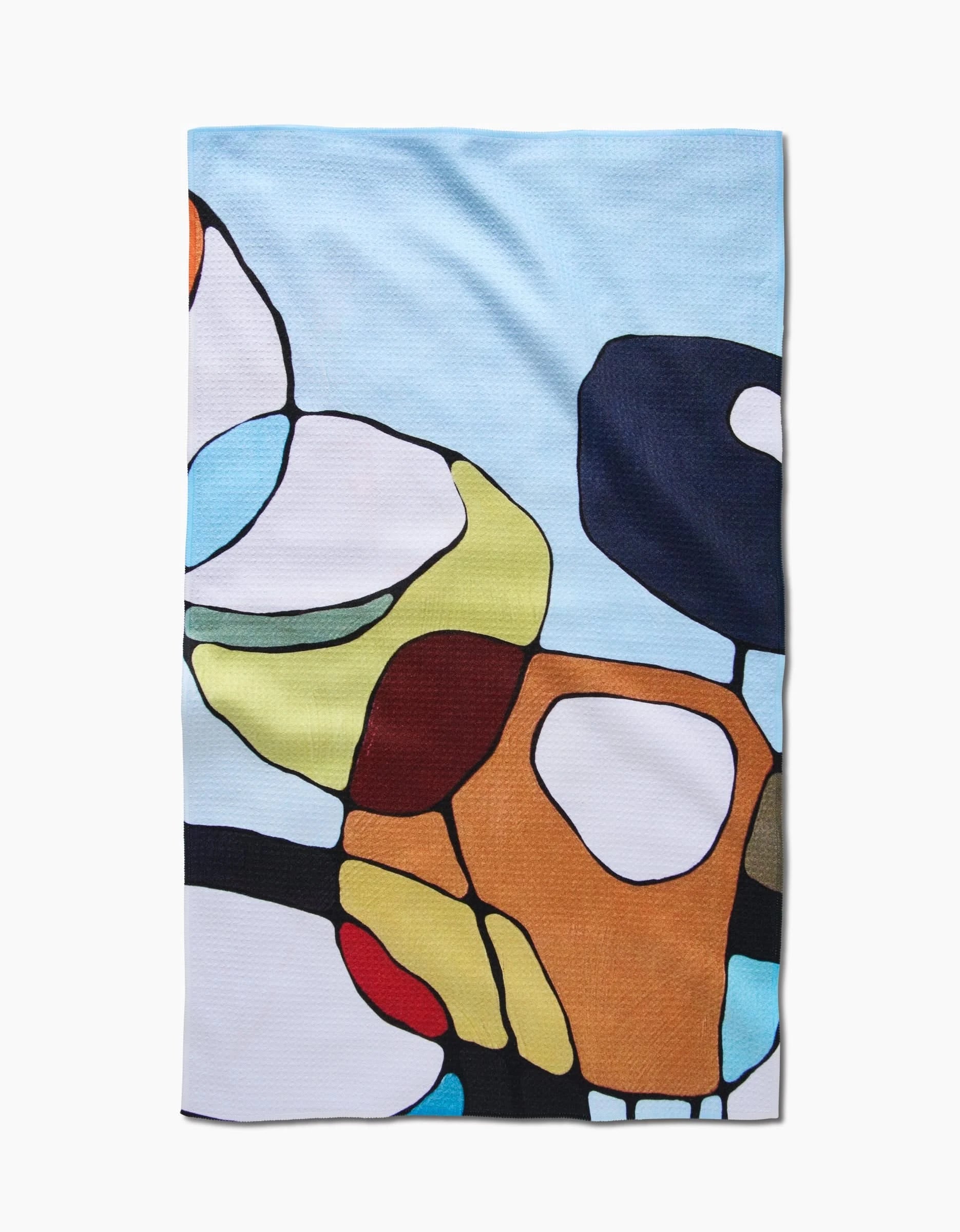 The Poppies on Blue tea towel by Rachel Austin features an abstract, colorful design with blue, white, yellow, brown, red, and black shapes on a light blue background. Made from soft Geoweave fabric for excellent absorbency and durability.