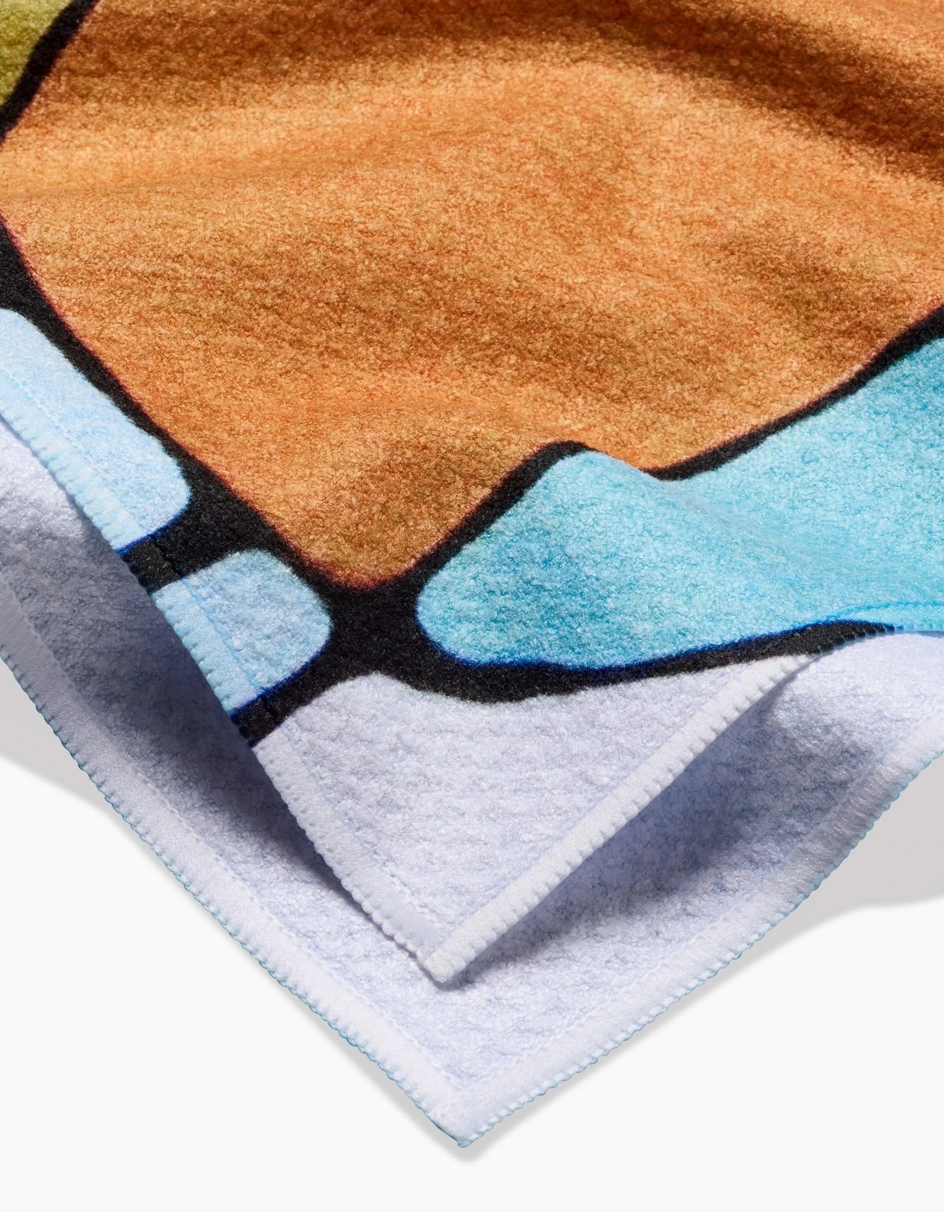 A close-up of the Rachel Austin Poppies on Blue tea towel, featuring vibrant abstract shapes and soft Geoweave fabric texture with neatly folded corners.