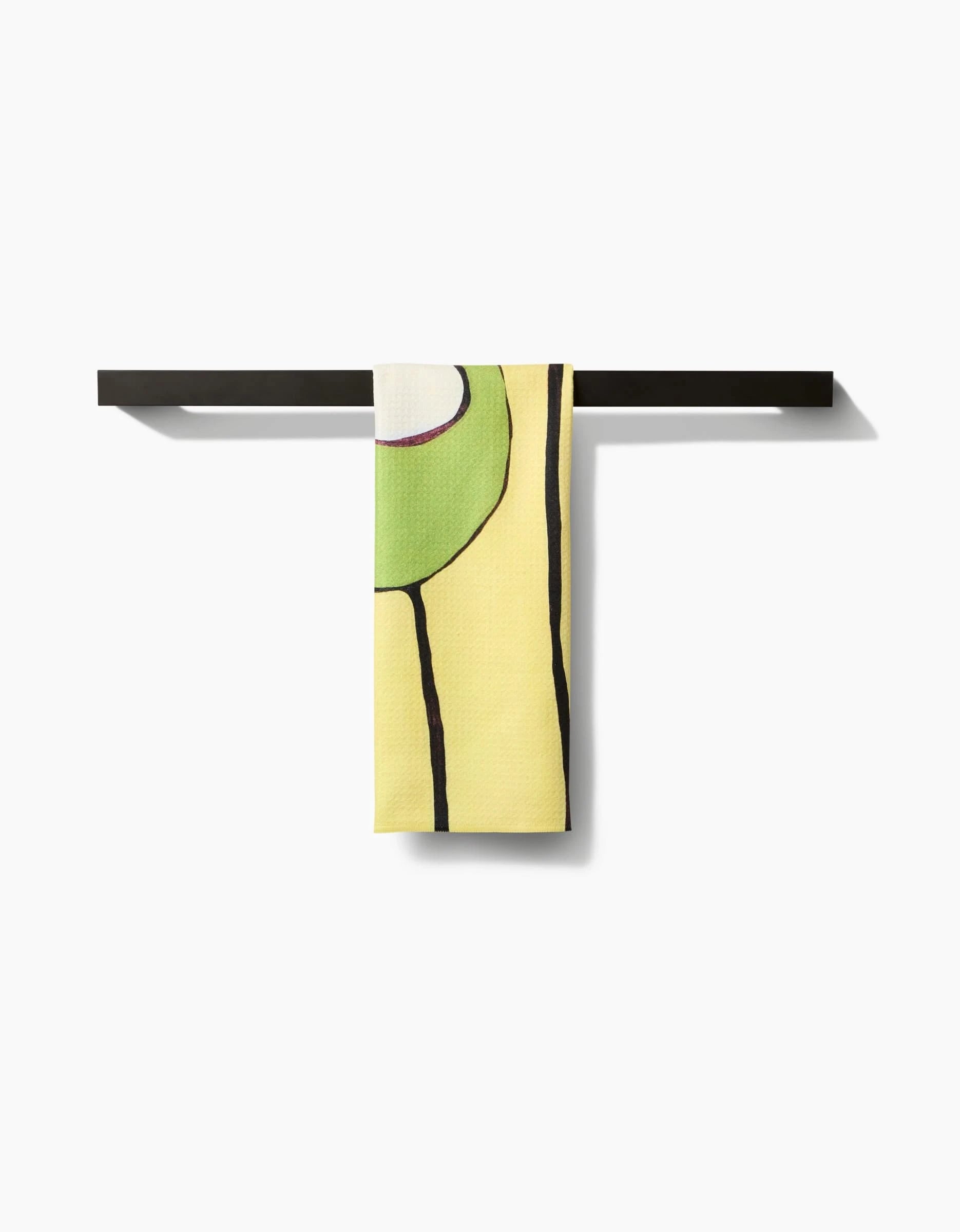 The Poppies on Yellow tea towel by Rachel Austin, crafted from Geoweave™ fabric, features a green and purple abstract design and hangs neatly over a black towel bar against a white background.