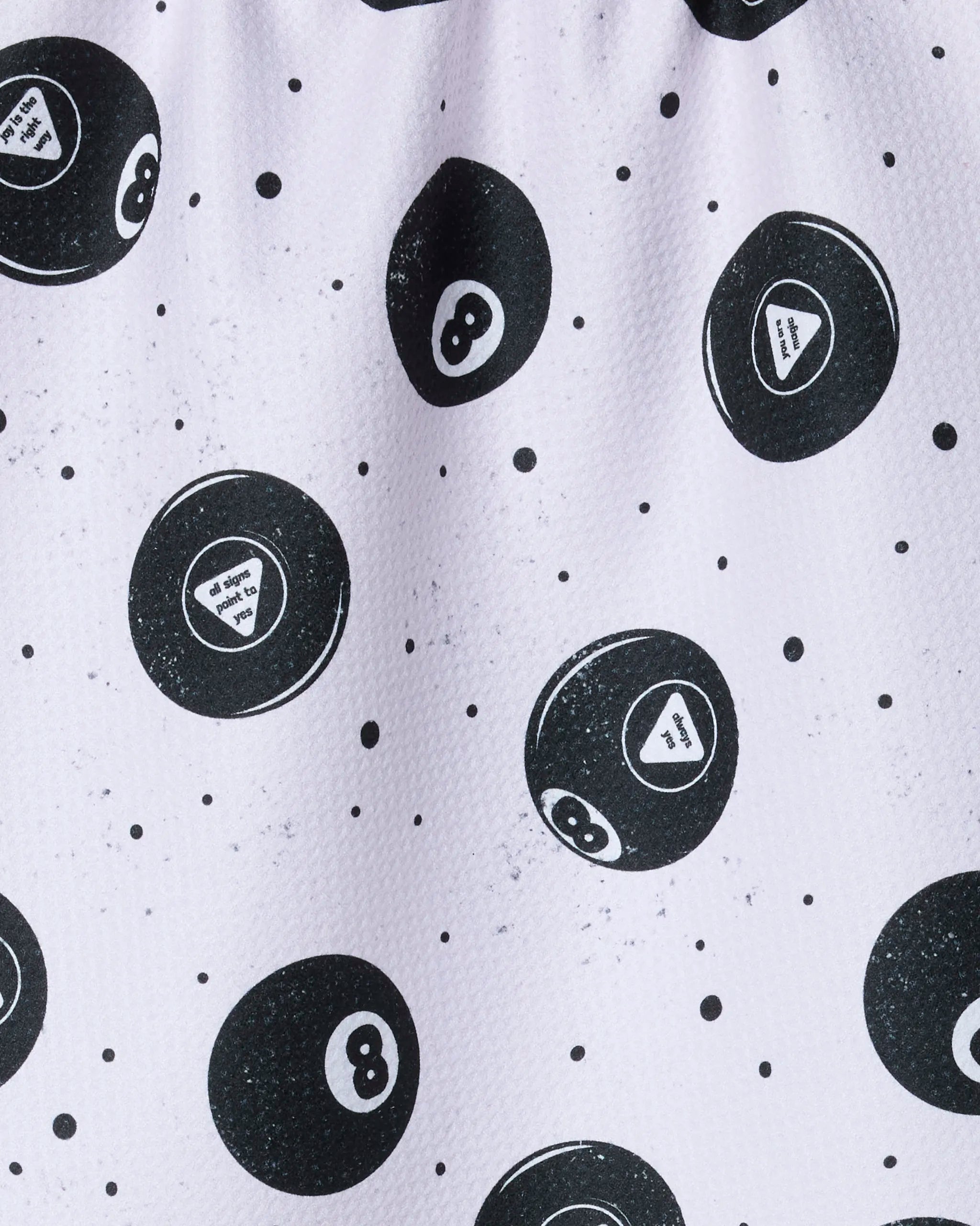 The Geometry "Positive Future" tea towel features black billiard 8 balls and Magic 8 Balls with white triangles, scattered on a quick-drying white textured towel made from recycled materials, accented with small black dots.