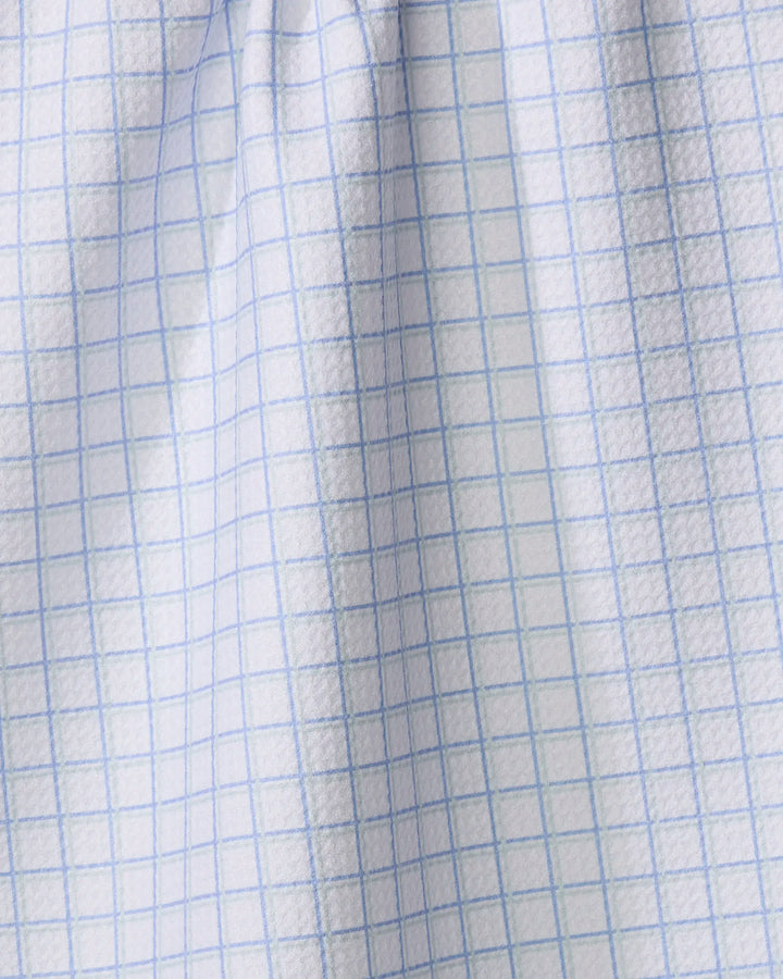 Close-up of The Buy Guide's Preppy - French Blue Mint: a textured sheet with light blue grid lines, its softly wrinkled surface bending the pattern, reminiscent of recycled kitchen towel folds.