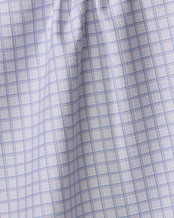 Close-up of The Buy Guide's Preppy - Lilac French Blue kitchen tea towel, featuring a white fabric with a blue grid pattern. Made from recycled materials, the textured fabric creates subtle shadows and highlights.