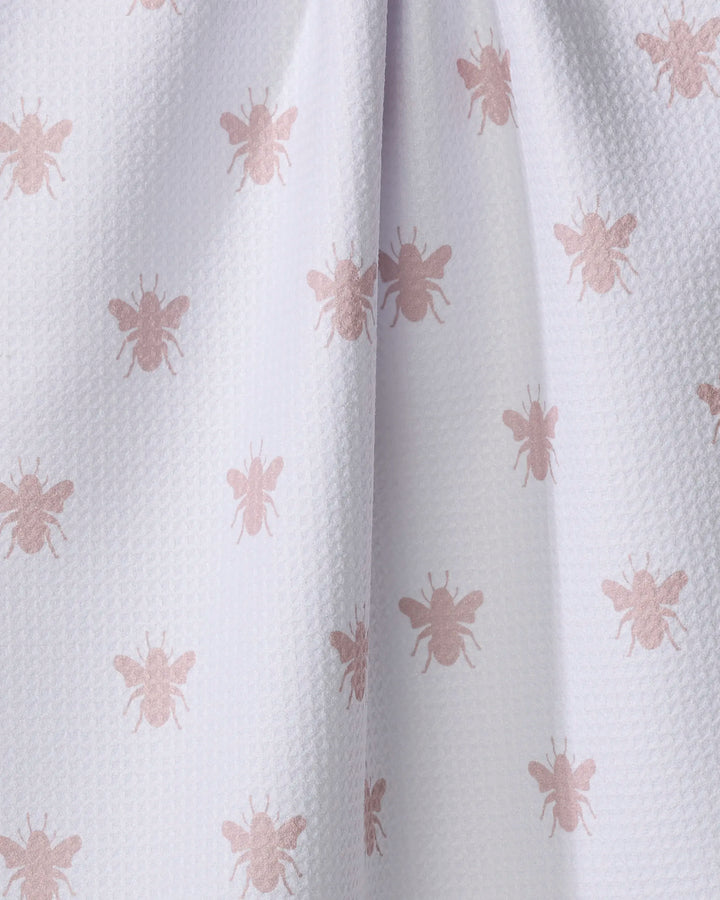 Close-up of The Buy Guide's Queen Bee - Dusty Rose tea towel, made from recycled Geoweave fabric, featuring a repeating pattern of light pink bees and a subtle drape in the center.