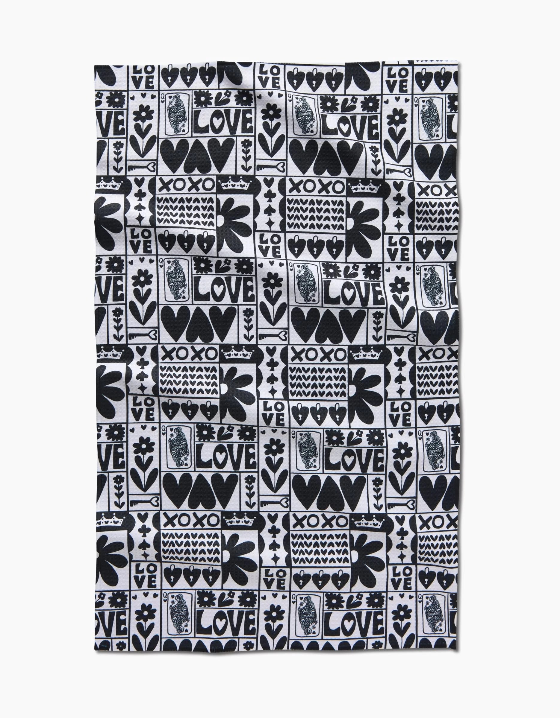 The Kayla Ann Queen of Hearts tea towel features black and white squares with hearts, flowers, stars, and bold LOVE and XOXO text in a striking graphic style.