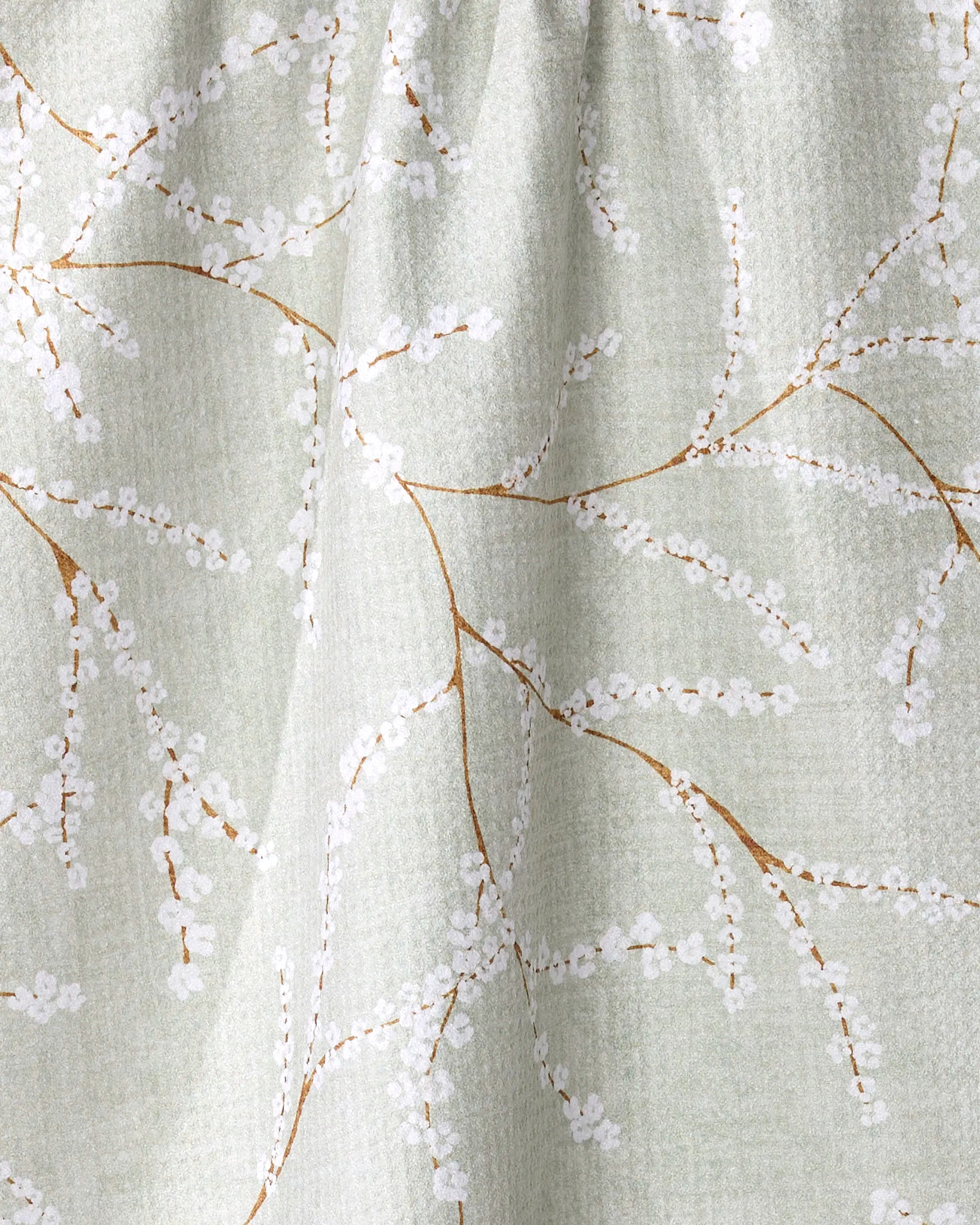 The Quiet Flowers kitchen towel by Pascale Dilger features light gray fabric with a subtle texture, delicate brown branches, and small white blossoms, evoking cherry or plum blossom motifs.