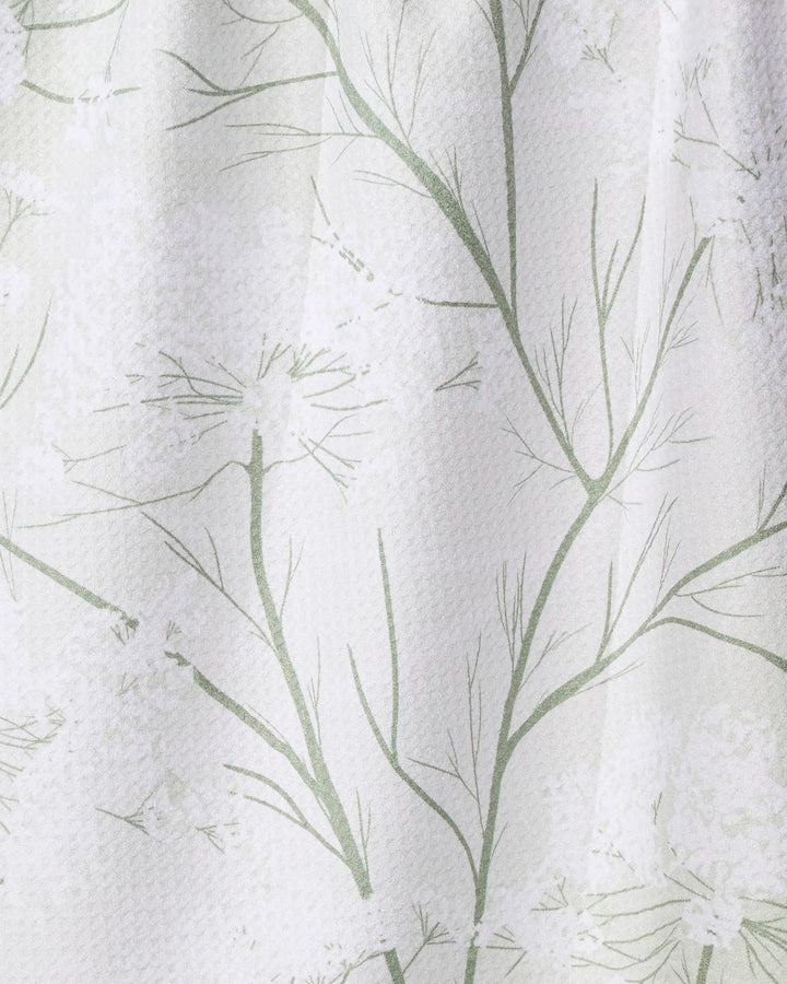 The Geometry Quiet Garden tea towel features a textured white design made from recycled materials, accented with a subtle green branch and leaf pattern for a soft, nature-inspired look.