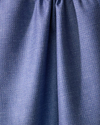 Close-up of Geometrys Rainfield, a blue absorbent kitchen towel crafted from recycled materials, with a subtle textured pattern and gathered seam near the top for soft folds and shadows.