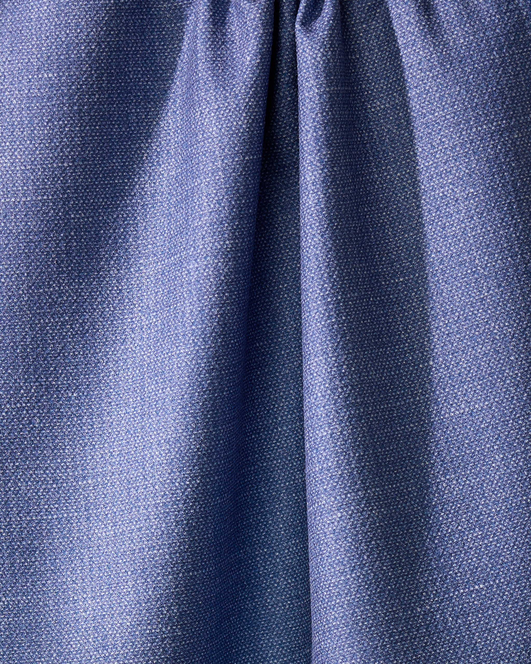 Close-up of Geometrys Rainfield, a blue absorbent kitchen towel crafted from recycled materials, with a subtle textured pattern and gathered seam near the top for soft folds and shadows.