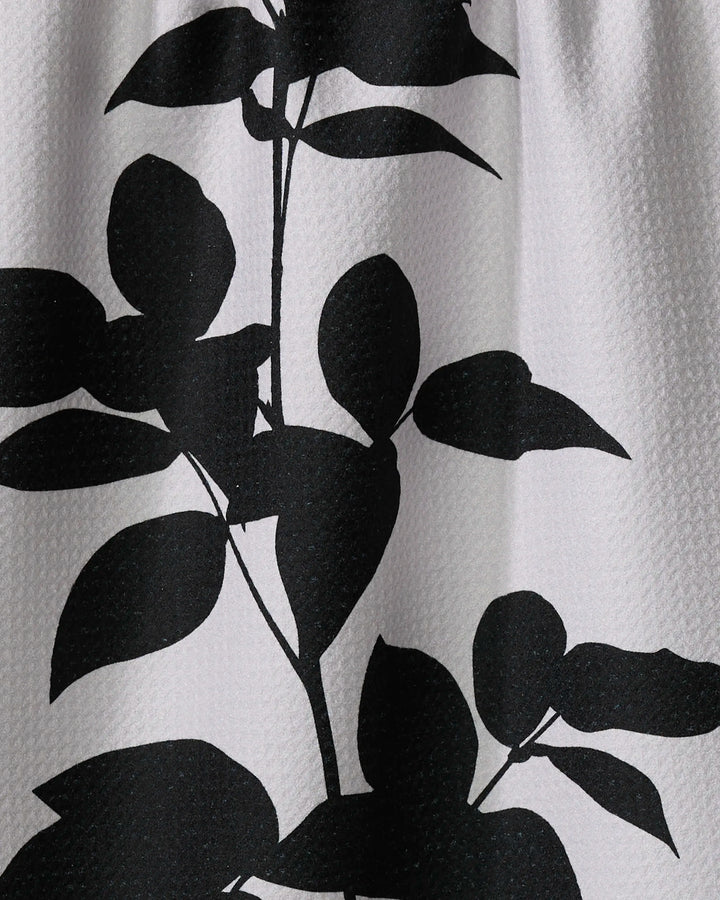 The Raspberry by PrintedPlant features a black silhouette of leafy stems with rounded leaves on textured white, ideal for a stylish recycled kitchen towel.