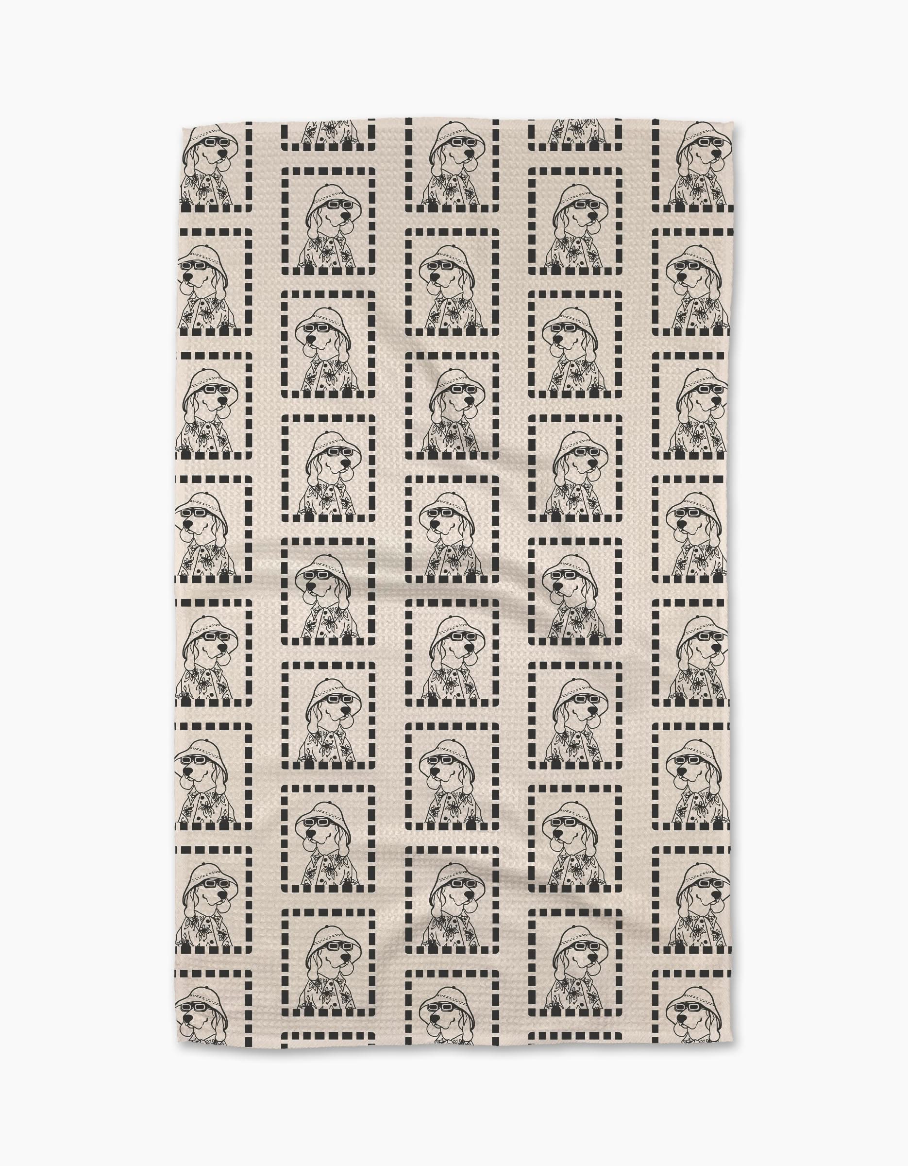 The Geometry Ready For Summer Doggy beige Geoweave™ tea towel features a grid of dotted square borders framing repeated black line drawings of a dog in glasses and a scarf.