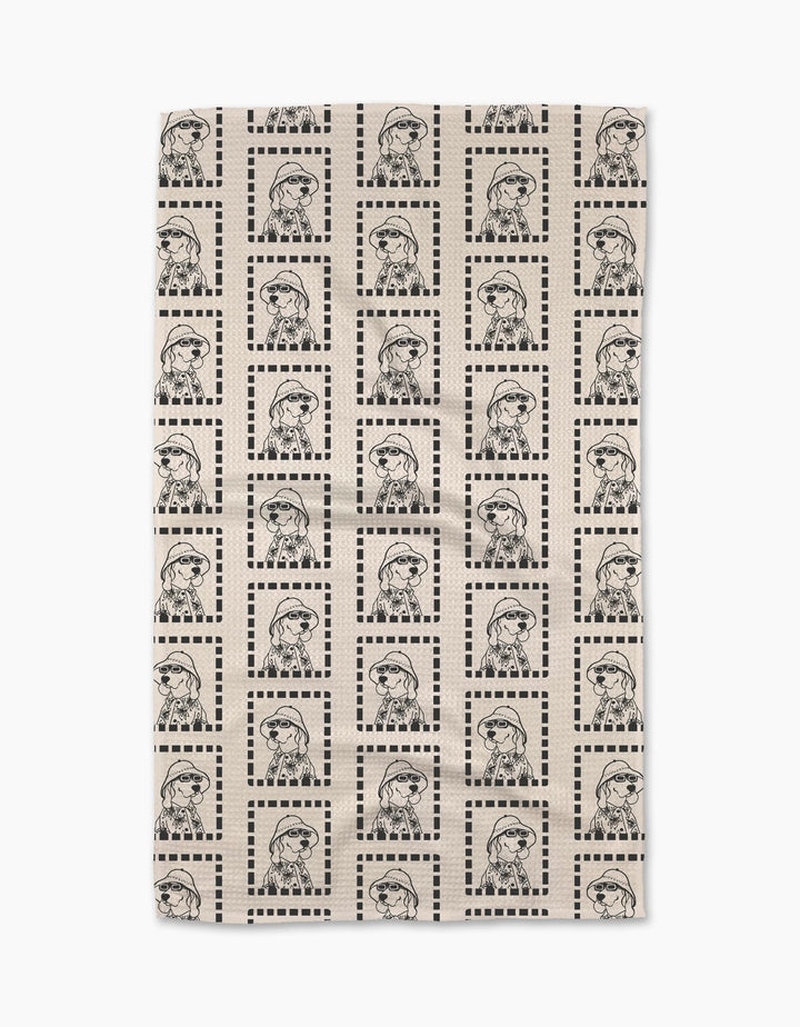 The Geometry Ready For Summer Doggy beige Geoweave™ tea towel features a grid of dotted square borders framing repeated black line drawings of a dog in glasses and a scarf.