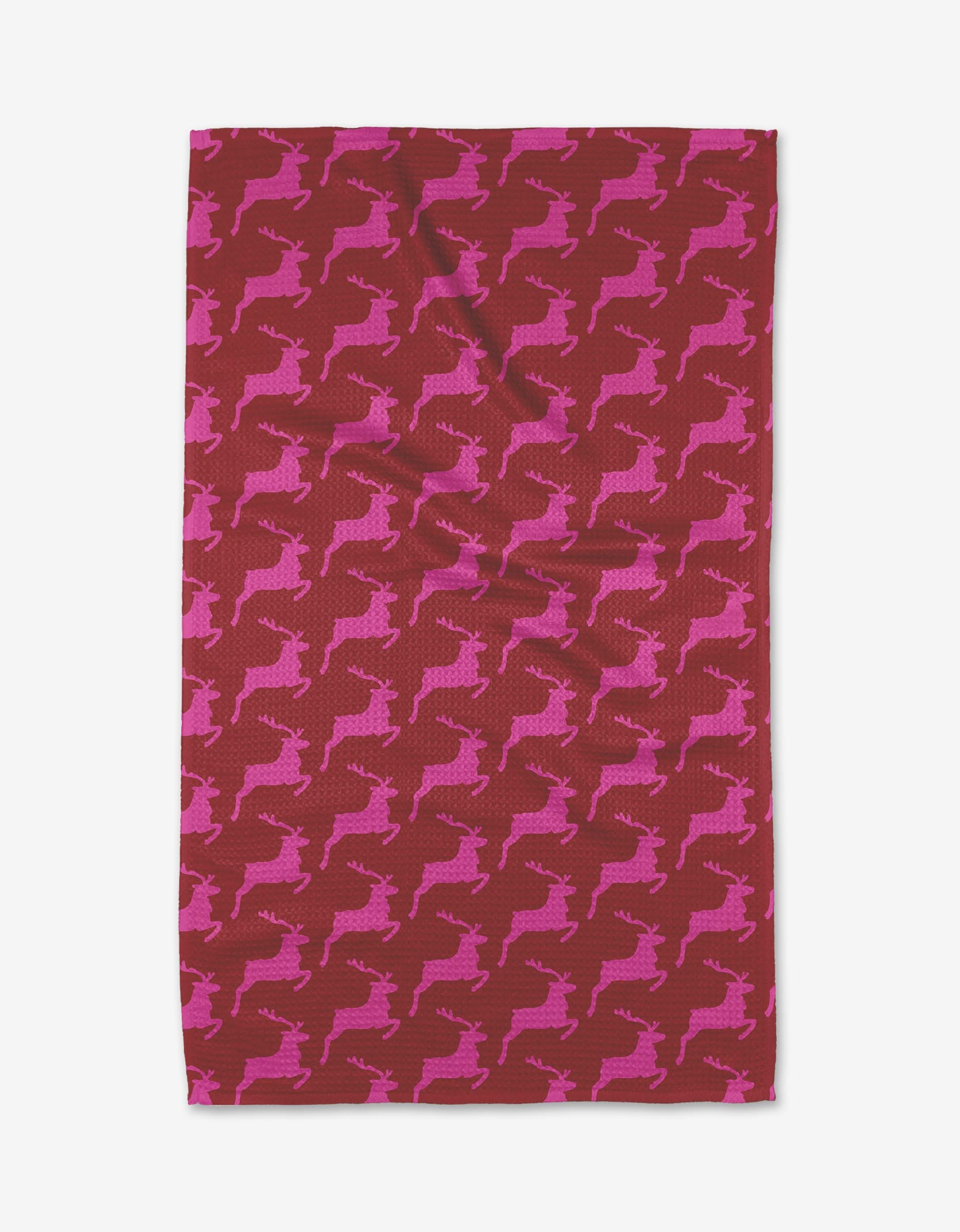 The Kayla Ann Red Reindeer is a rectangular red kitchen towel with rows of pink reindeer silhouettes in leaping poses, made from recycled materials.