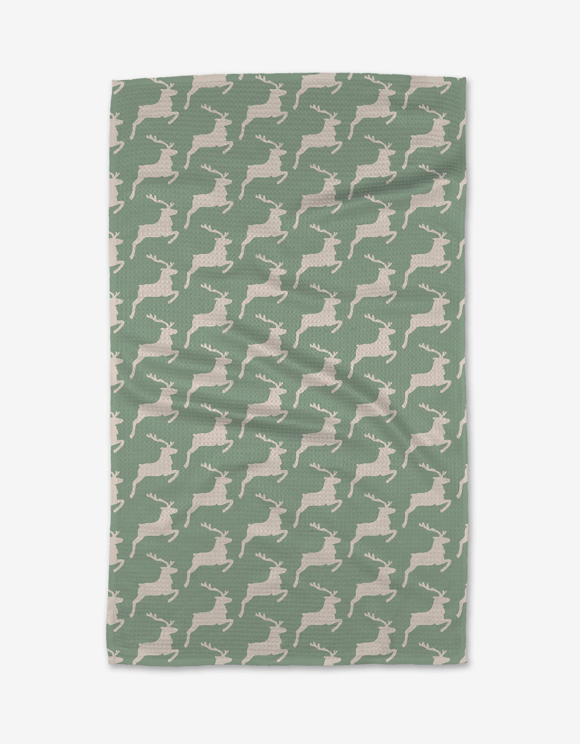 The Kayla Ann Reindeer blanket is green with a textured finish, made from recycled materials, and showcases a repeating pattern of white reindeer silhouettes facing right. It’s displayed flat on a white background.