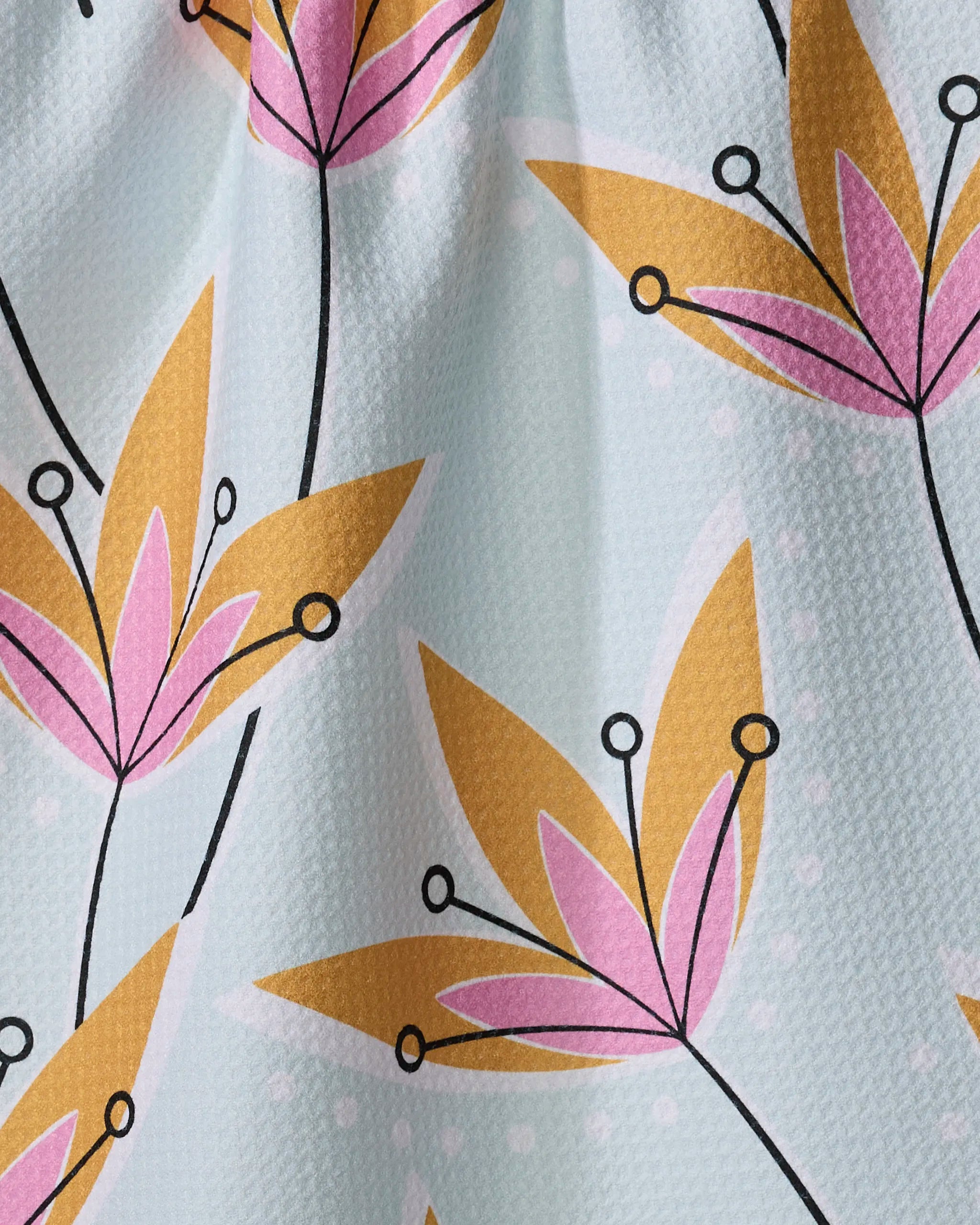 A close-up of Retro Floral by Julianne Haness shows yellow and pink stylized flowers with black stems on a light background—ideal for recycled kitchen or quick-drying towels.