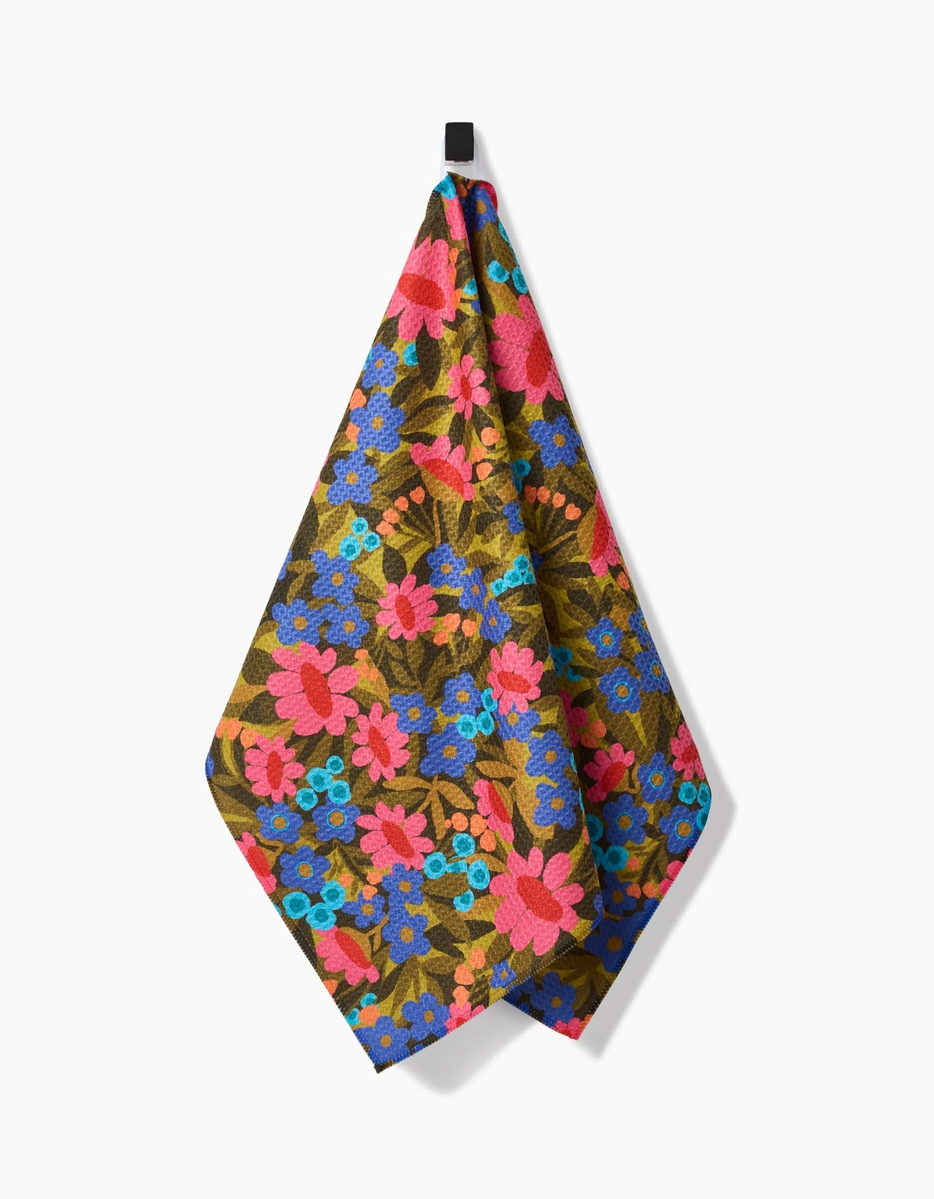 The Retro Garden hanging tea towel by Lisa Nelson features a vibrant floral pattern with pink, red, and blue flowers on a brown background and is made from ultra-absorbent Geoweave fabric.
