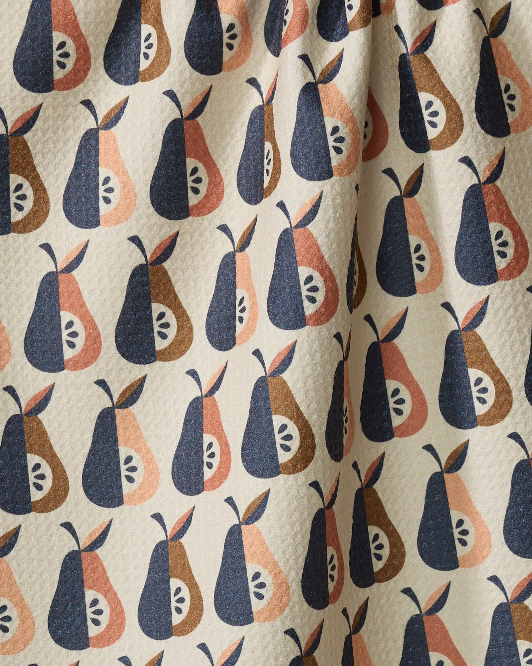The Retro Pears towel by Megan Kampa showcases a repeating pattern of stylized pears in navy, brown, and peach on beige. Ultra-absorbent with a quilted texture, its gentle folds add to the stylish retro appeal.