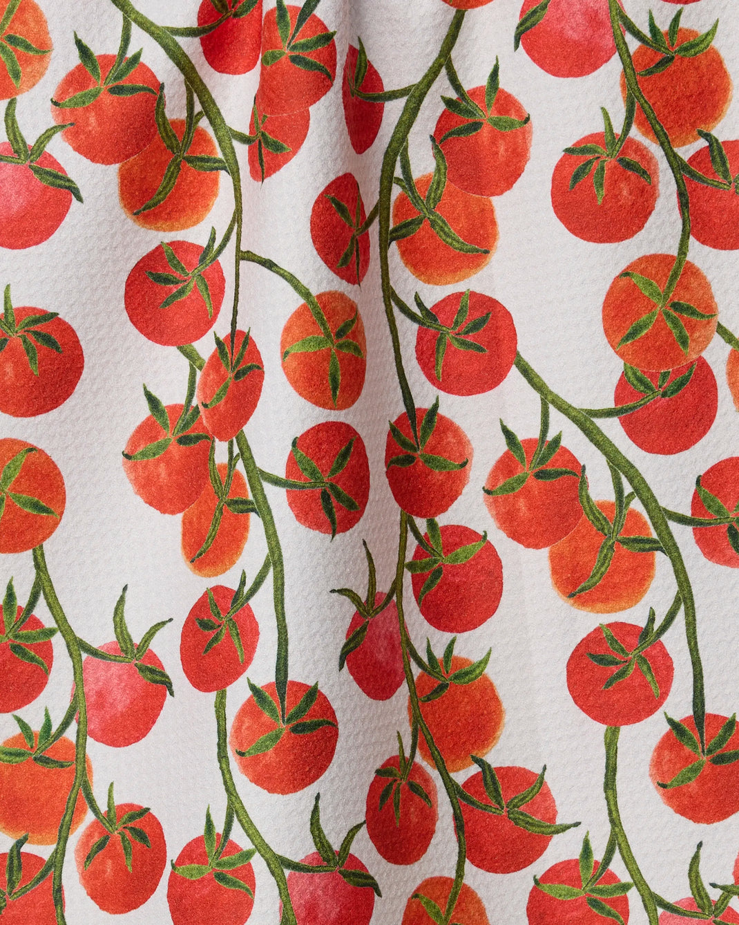 Ripe and Ready" by Geometry features a watercolor-style pattern of red tomatoes on green vines over a white background. This ultra-absorbent towel adds vibrant charm and style to any kitchen, even when slightly wrinkled.