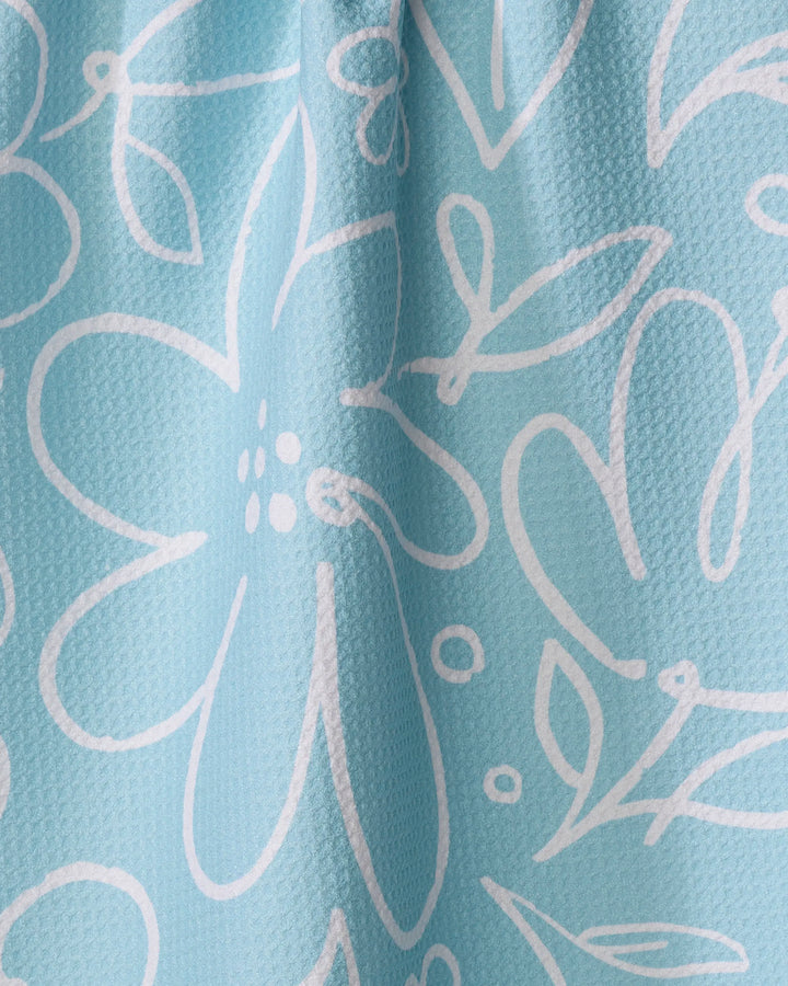 River Blossom by Sara Mari features light blue textured fabric with a white, hand-drawn floral pattern. Ultra-absorbent and stylish, it's the perfect tea towel to add function and flair to your kitchen.