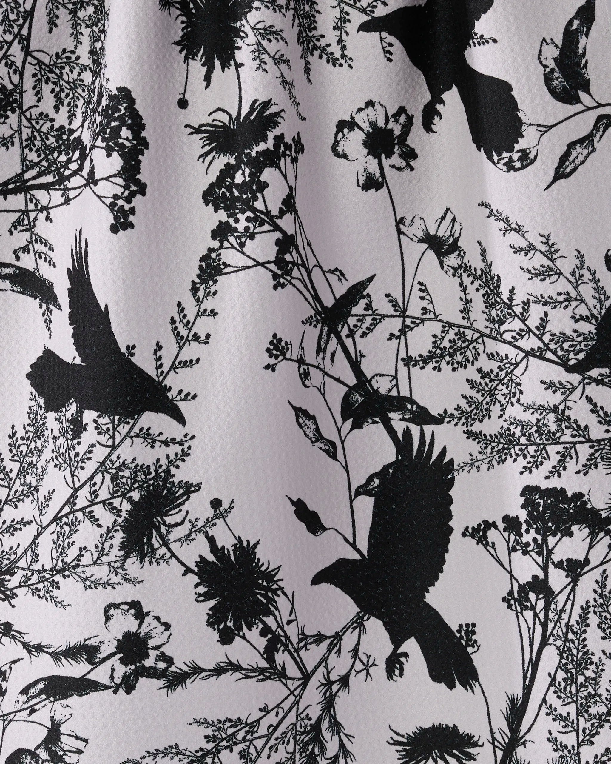 Geometry’s Rookery tea towel features black bird and wildflower silhouettes on a light background. Made from recycled materials, it brings a detailed, nature-inspired touch to your kitchen decor.