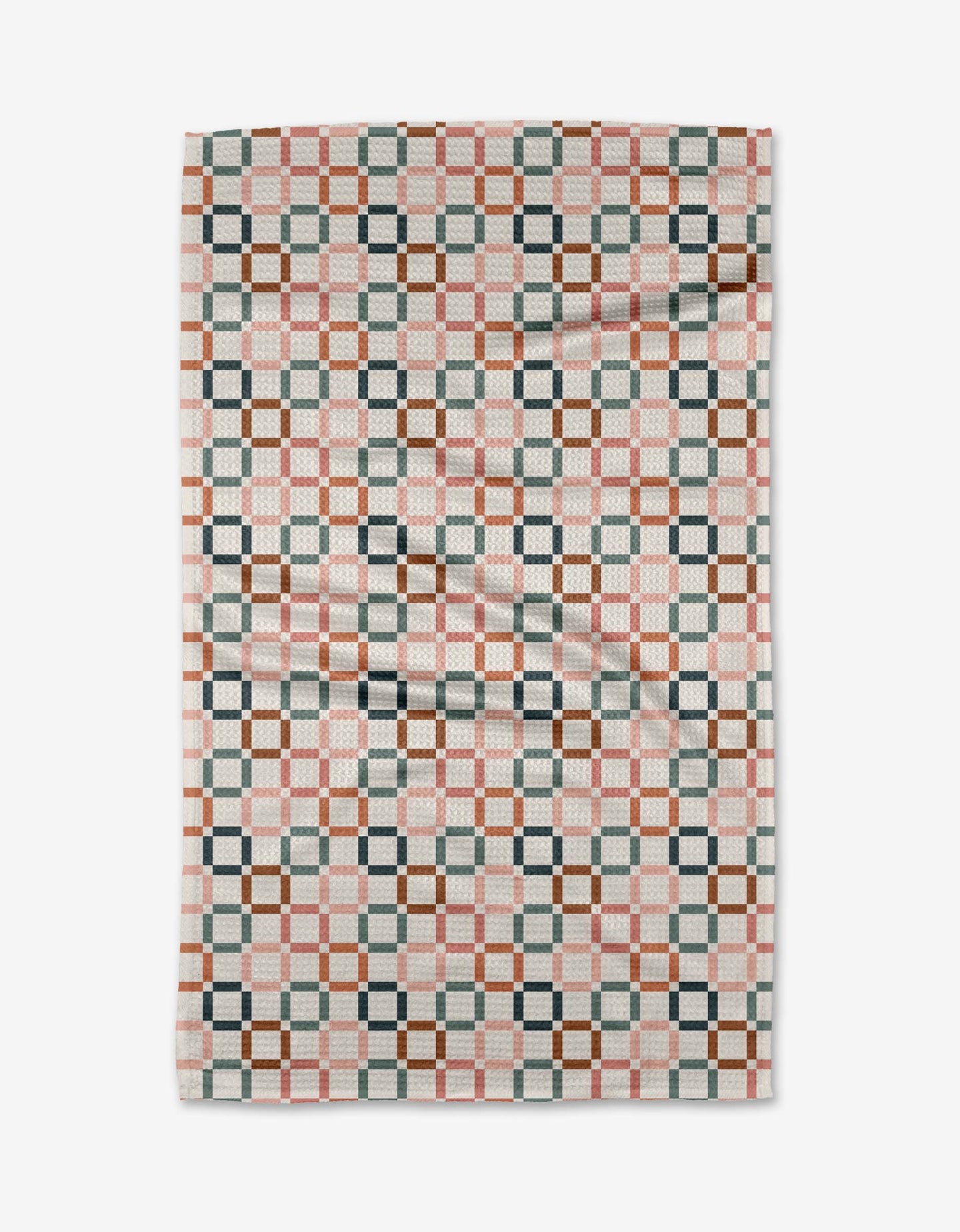 The Russet Crossroads blanket by Charlie Rowan Designs features a geometric checkerboard pattern in pink, brown, gray, and white Geoweave fabric, with interlocking shapes for a modern look—reminiscent of the cozy Geometry House Tea Towel. Slightly wrinkled.