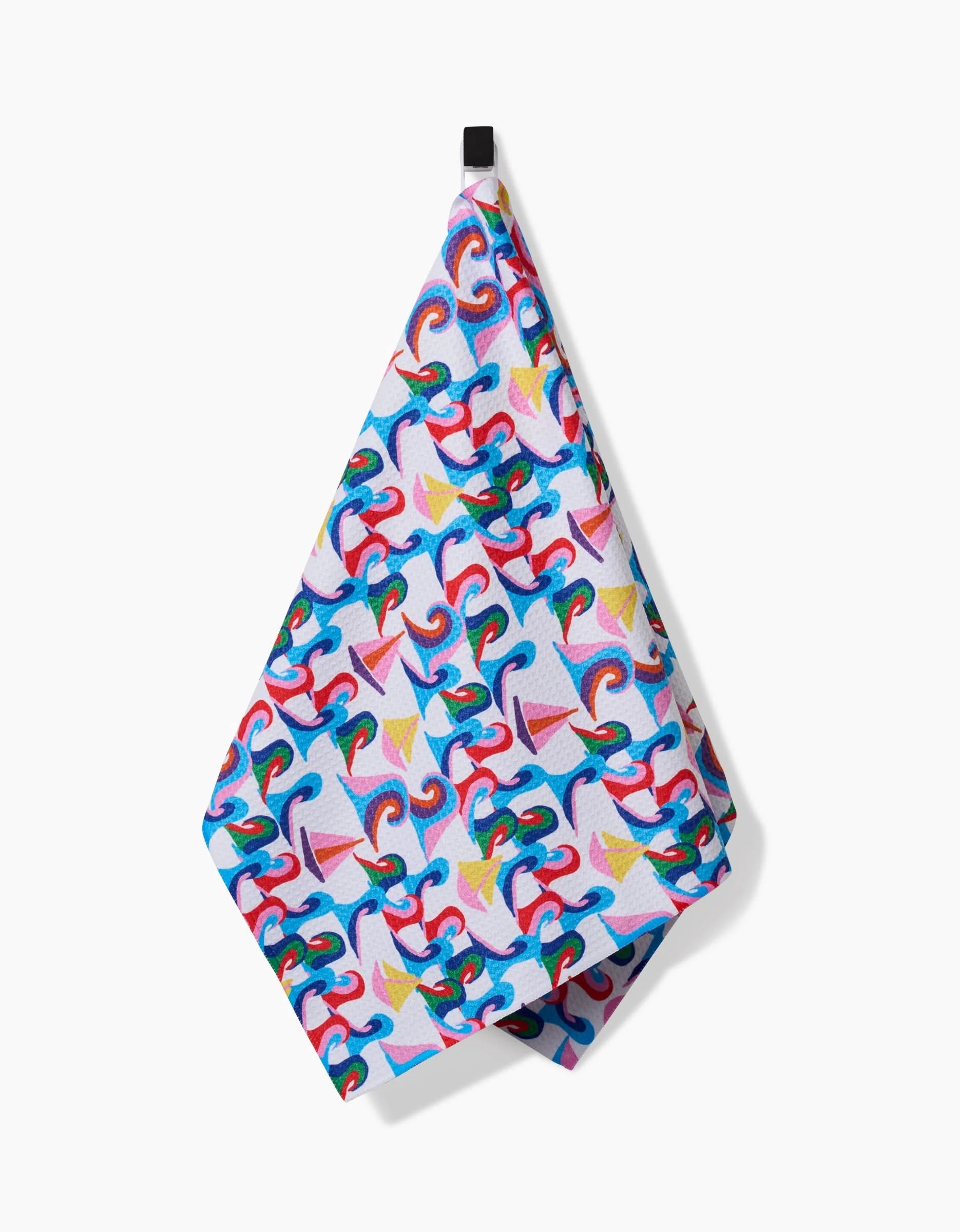 The Sail Safe towel by Ania Zwara Art features a vibrant abstract design with swirls and sailboats in blue, red, yellow, and pink on ultra-absorbent Geoweave fabric, shown hanging from its black loop on a white background.