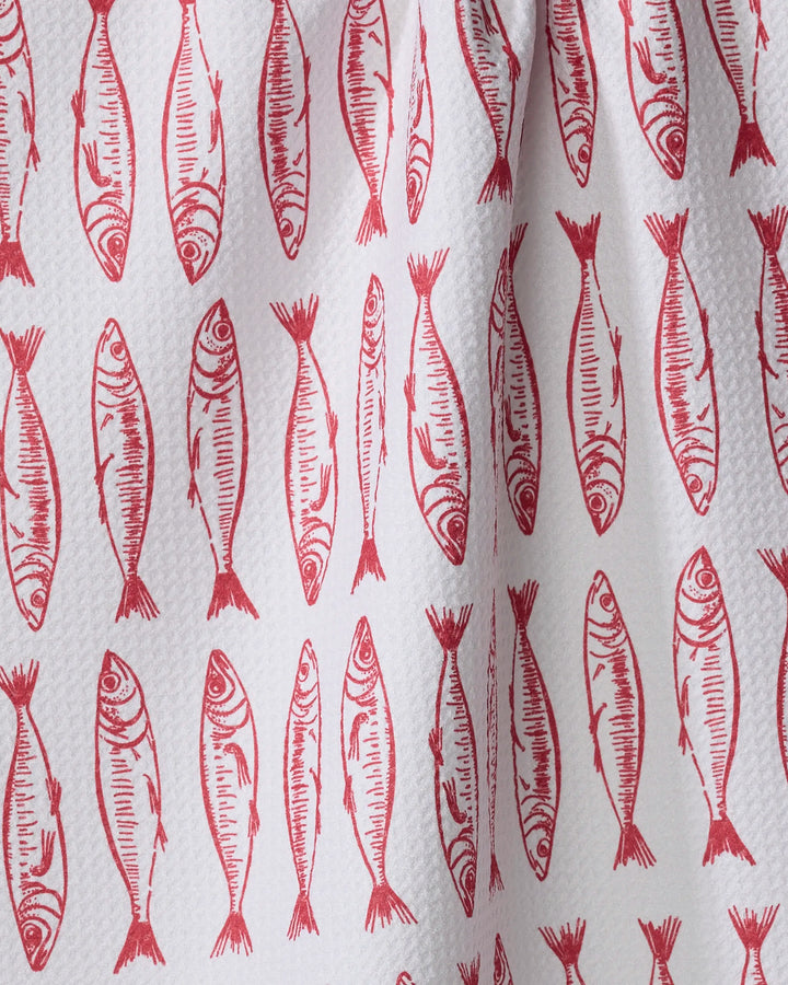 A close-up of Hufton Studio's "Sardine Stripes" tea towel—an eco-friendly white towel with red, hand-drawn sardine illustrations in vertical rows.