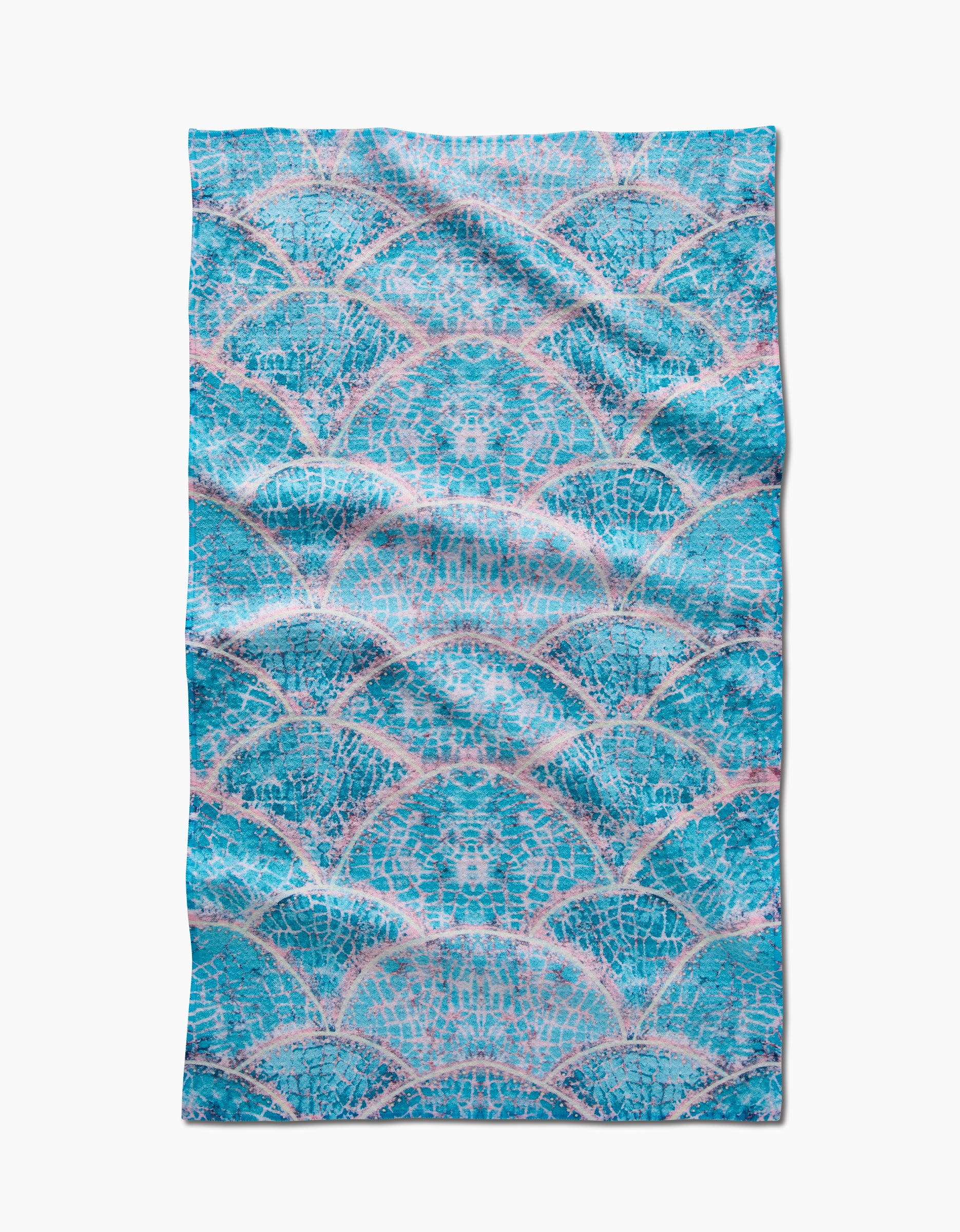 The Scallop Hills tea towel by Taryn Brennan features a blue and pink scallop pattern inspired by mermaid scales, made from ultra-absorbent recycled materials and shown flat on a white background.