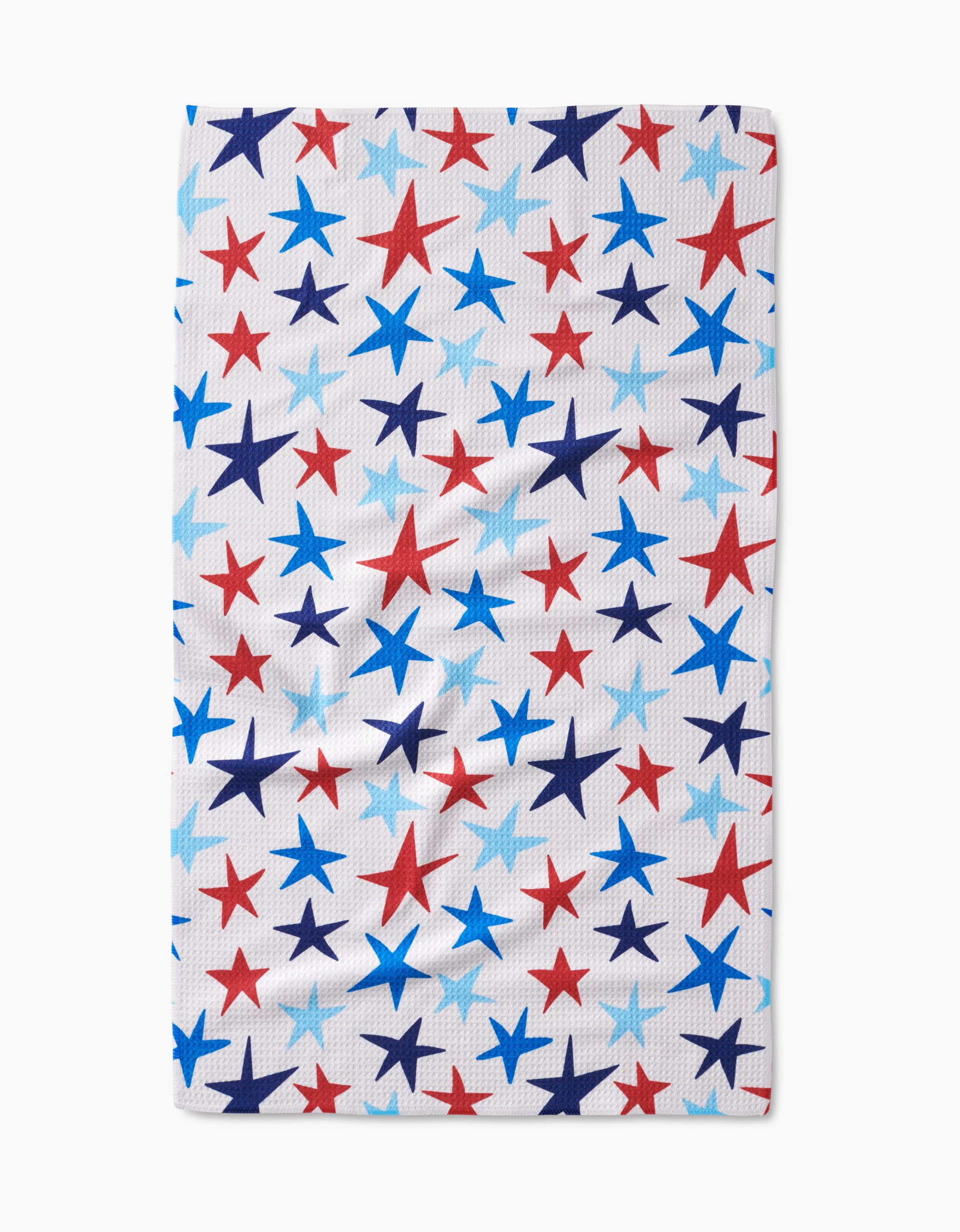 The Mindfulnice Seeing Stars tea towel is white and rectangular, featuring red, blue, and light blue stars in various sizes on Geoweave™ fabric.