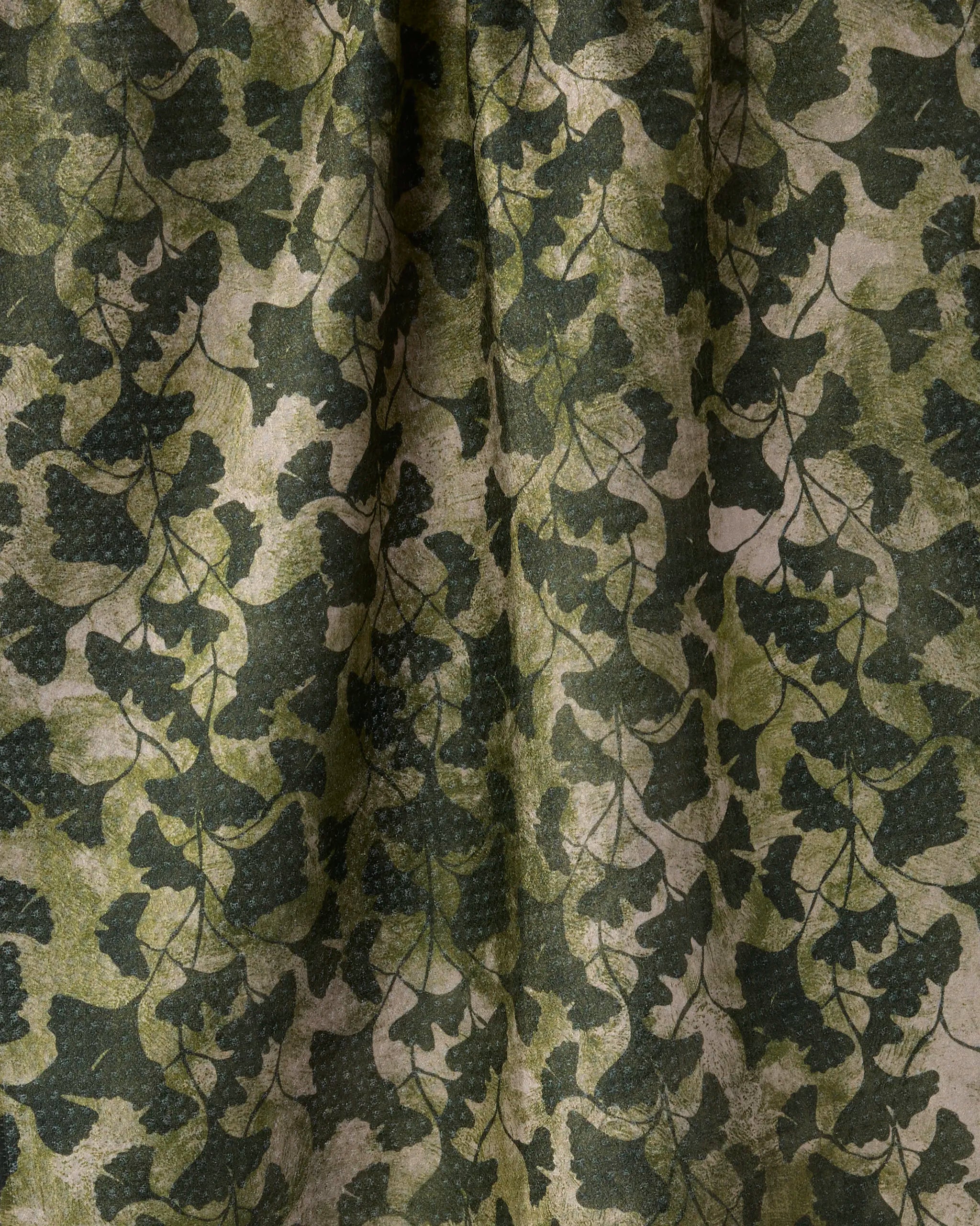 Shadow Grove by Geometry features a leafy camouflage pattern in green and brown on Geoweave fabric—overlapping leaf and branch silhouettes create a textured, natural look, making it the perfect eco-friendly tea towel made from recycled materials.