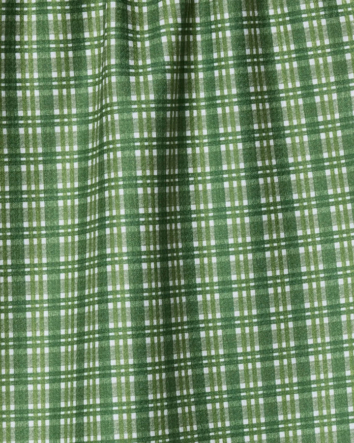 The Geometry Shay Plaid kitchen towel features a green and white intersecting line design for a checkered look. Its soft texture and gentle folds make it perfect for everyday use.
