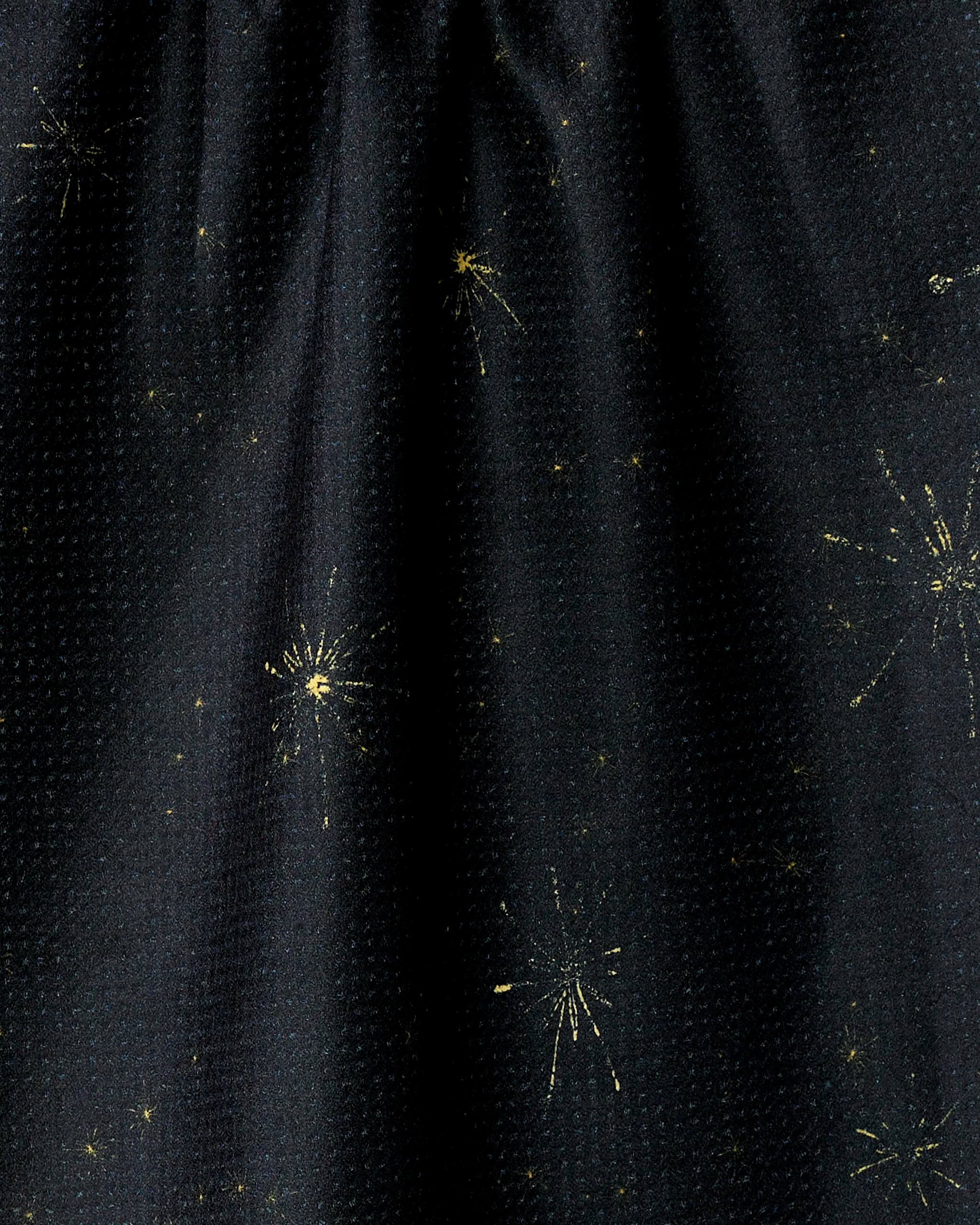 Introducing Shimmer Eve by Geometry: a dark fabric kitchen towel featuring subtle, scattered gold starburst patterns reminiscent of fireworks or stars. Made from recycled materials for an eco-friendly touch.