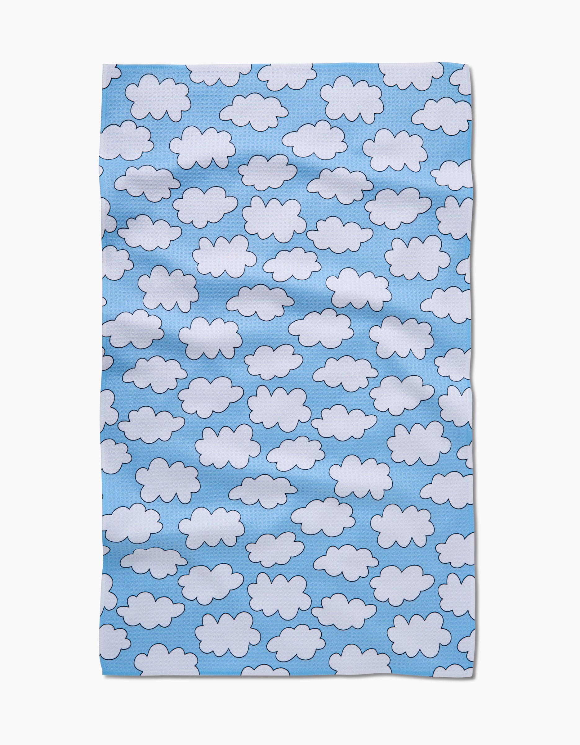 The Mindfulnice Silver Linings rectangular cloth showcases white cartoon clouds on a light blue background, crafted from eco-friendly, ultra-absorbent Geoweave fabric with a slightly wrinkled look.