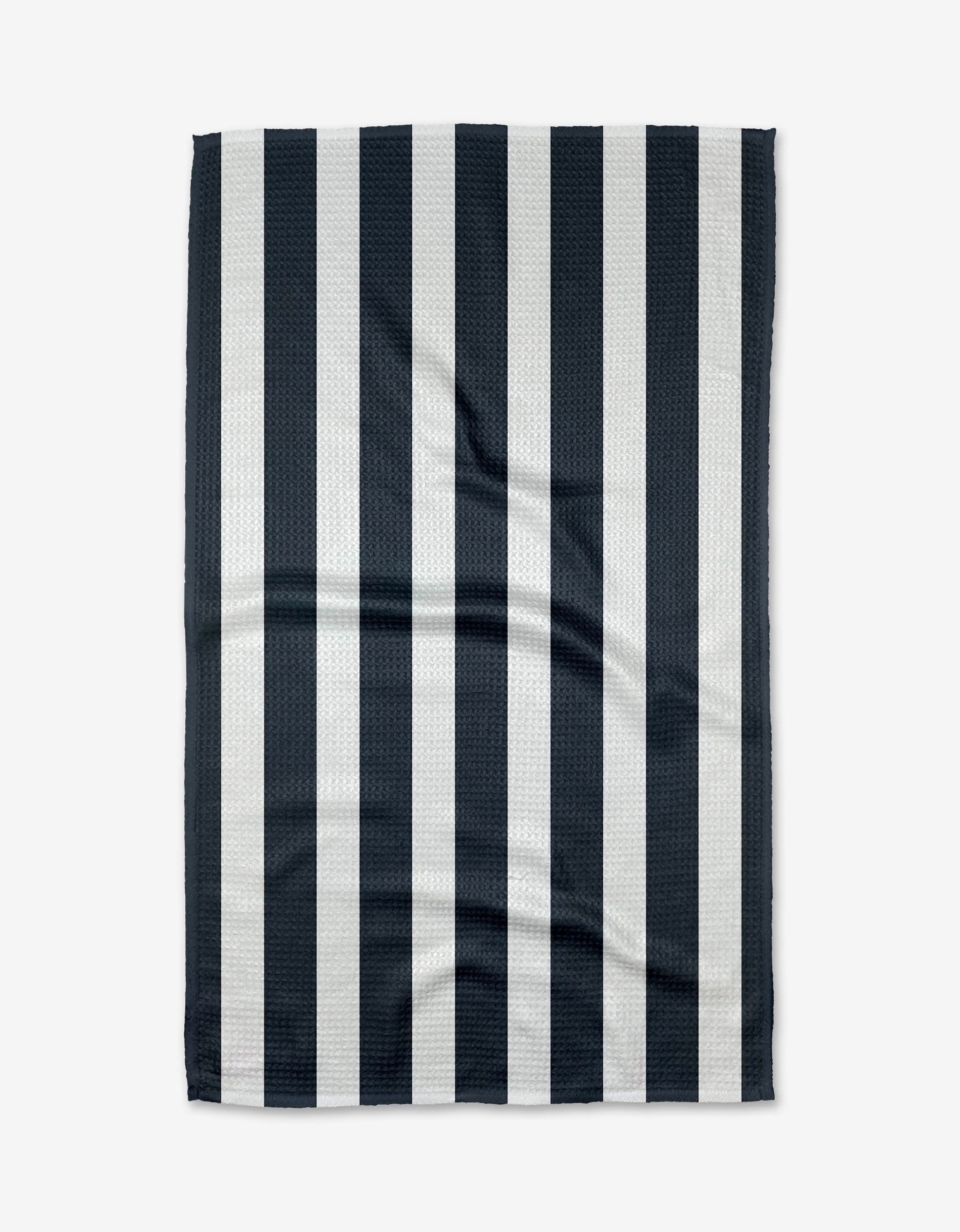 A rectangular BetterDays Sleep Geoweave fabric with evenly spaced vertical black and white stripes is shown flat on a white background, displaying subtle creases and folds on its ultra-absorbent surface.