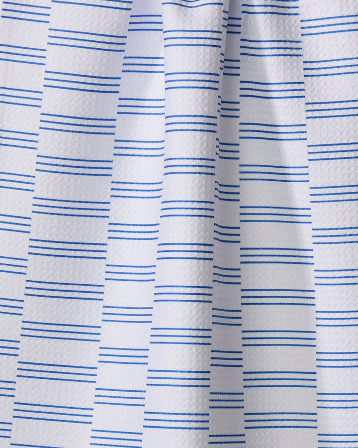 A close-up of The Buy Guide’s Small Stripe - Navy tea towel shows white, textured recycled fabric with evenly spaced navy blue stripes and soft vertical folds.