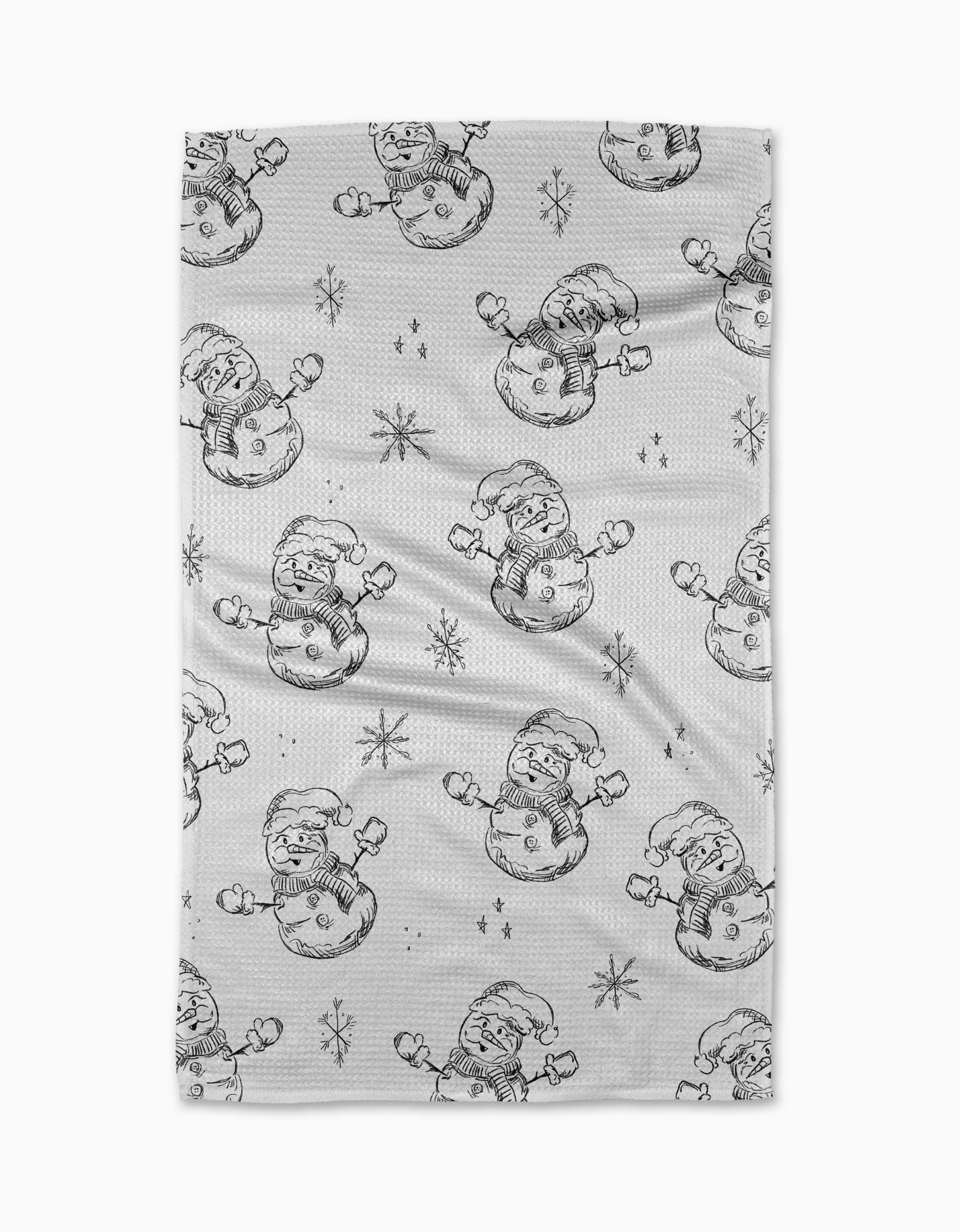 The Aubrey Fairchild "Snowmen Charcoal" kitchen towel features hand-drawn snowmen in Santa hats and scarves with sketch-style snowflakes, all in black lines. Made from recycled materials, it's a charming holiday accent.