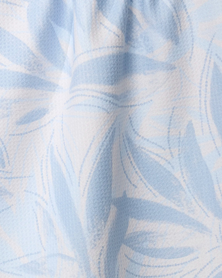 Close-up of Geometry’s Soft Breeze tea towel: ultra-absorbent, light blue and white with an abstract leafy pattern, overlapping curved lines, and soft shapes in varying blue shades on a slightly textured surface.