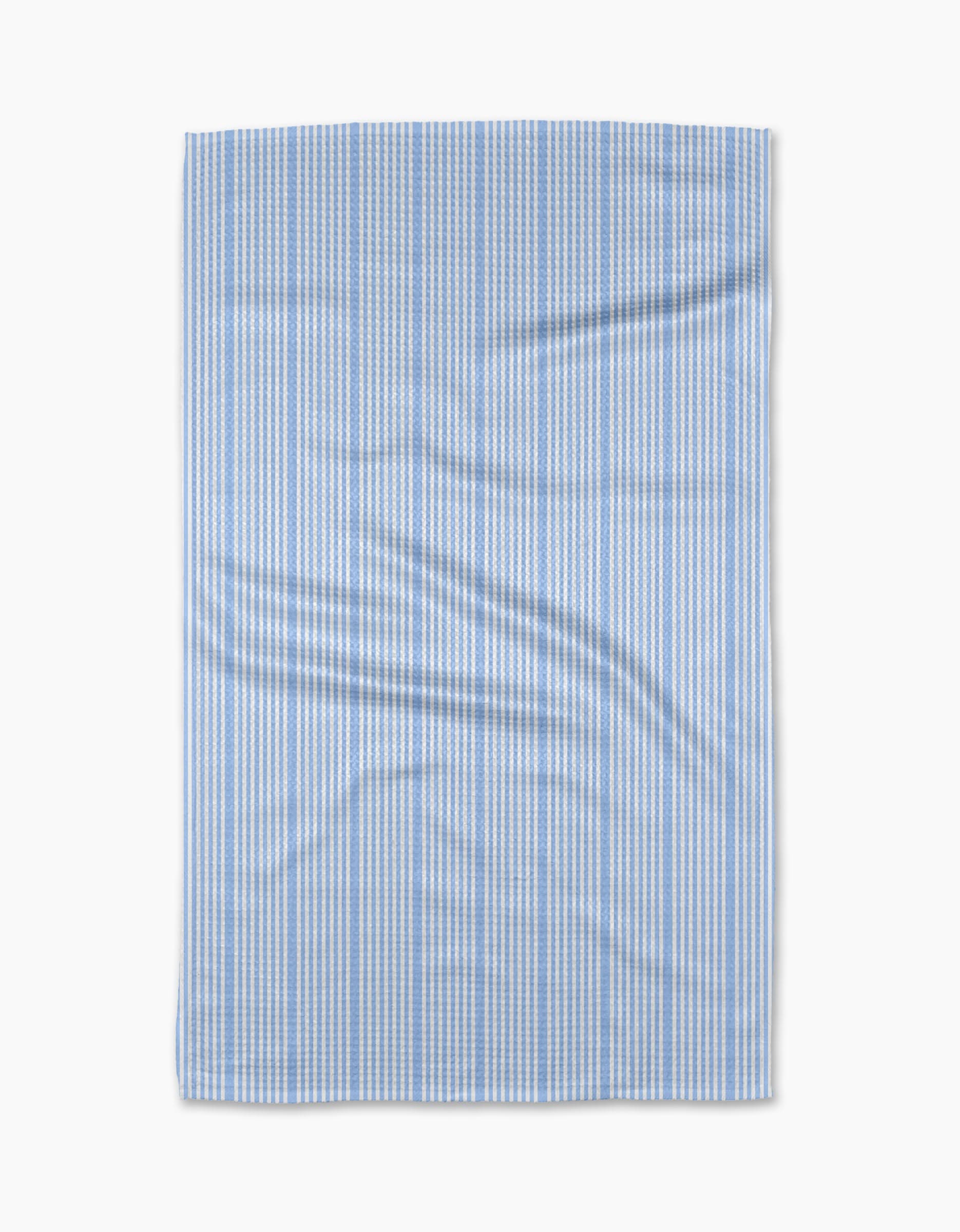 The Geometry “Soft Summer Blue” tea towel features thin vertical blue and white stripes on ultra-absorbent Geoweave fabric, displayed flat with subtle creases against a plain white background.