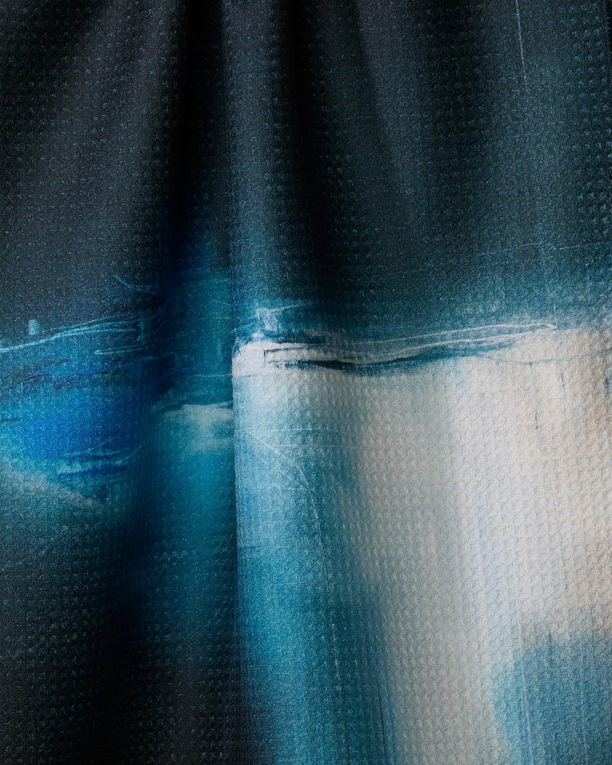 Somewhere by Jennifer Janesko features a textured blend of blue, white, and black in a gradient, evoking painterly style and soft light—reminiscent of a recycled-material tea towel.