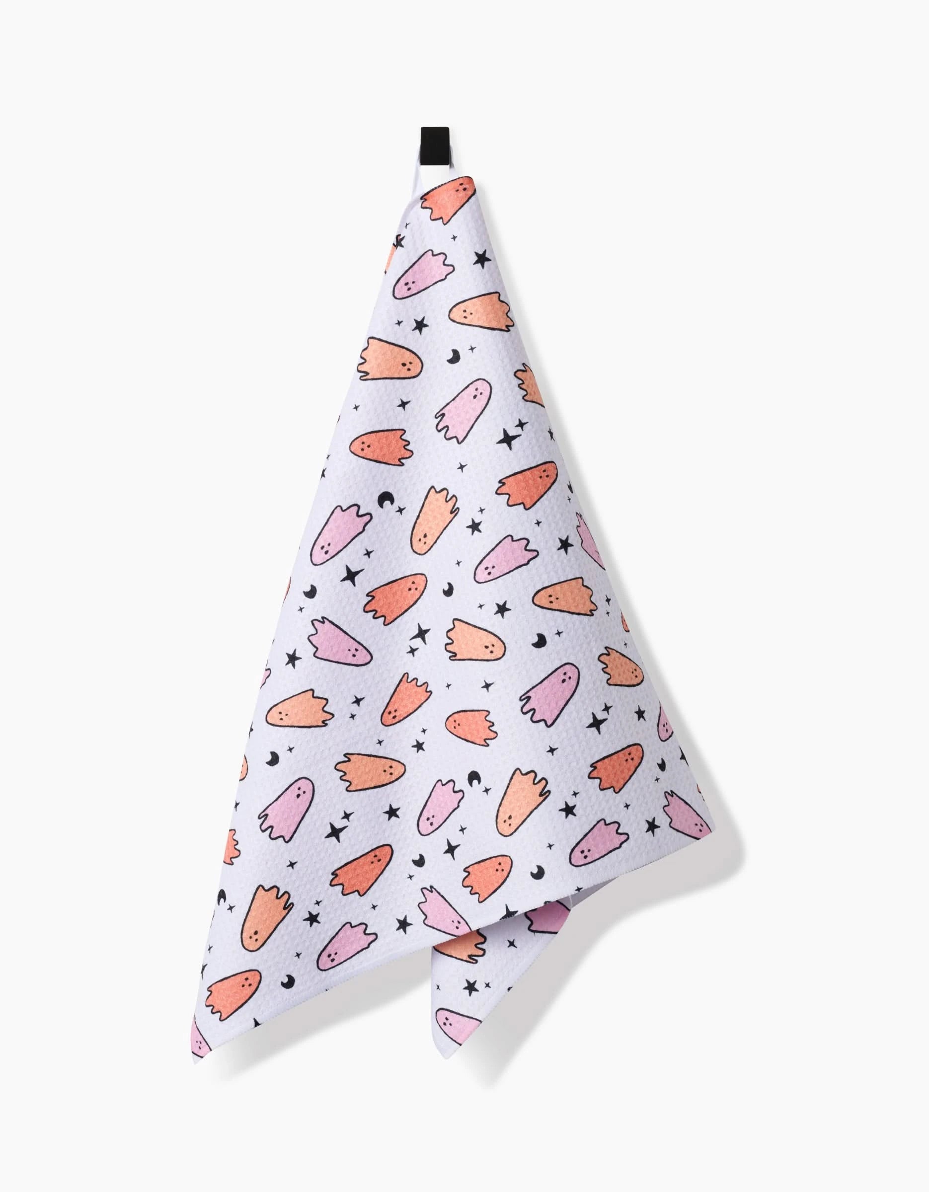 The Hufton Studio Space Ghosts Pink Orange tea towel features quick-drying white fabric with pink and orange cartoon ghosts, black stars, and a black hanging loop at the top.