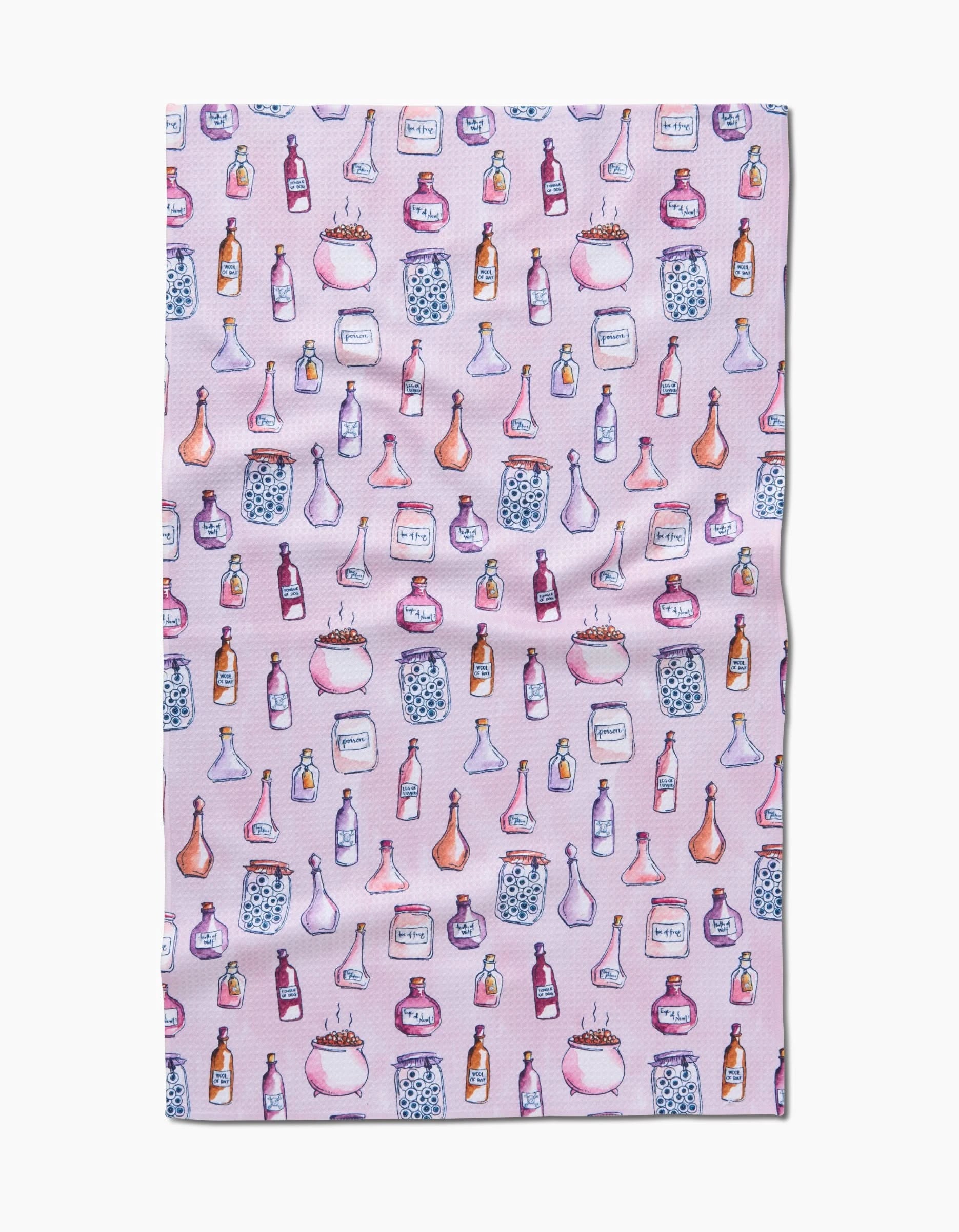 The Spells Potions quick-drying towel by Maayan Alper-Swan features a pink background with a repeating pattern of watercolor-style potion bottles, jars, and cauldrons in various shapes and colors.