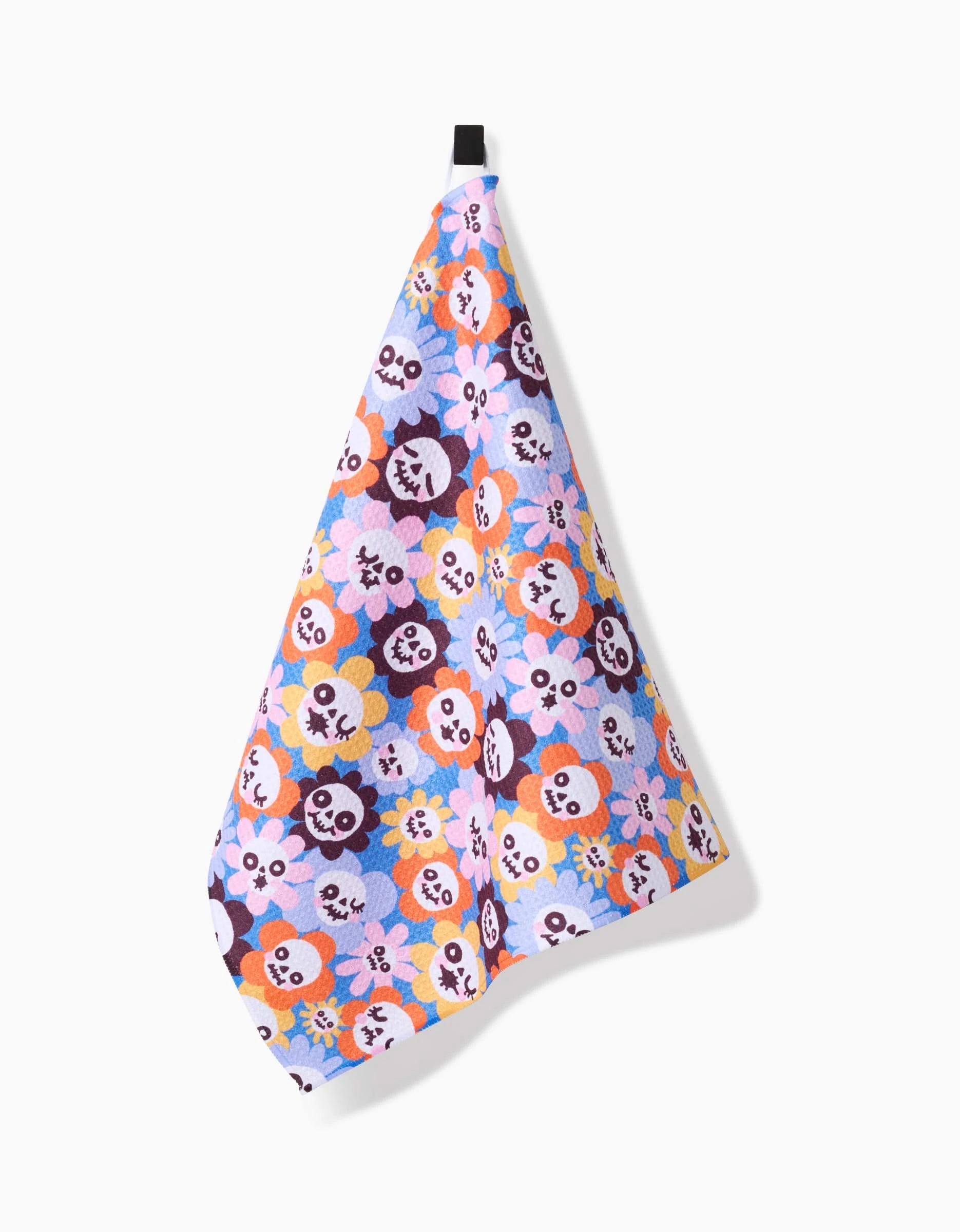 The So Lazo Spooky Bouquet tea towel, crafted from recycled materials, displays a vibrant pattern of cartoon animal faces and hangs by a black loop against a white background.