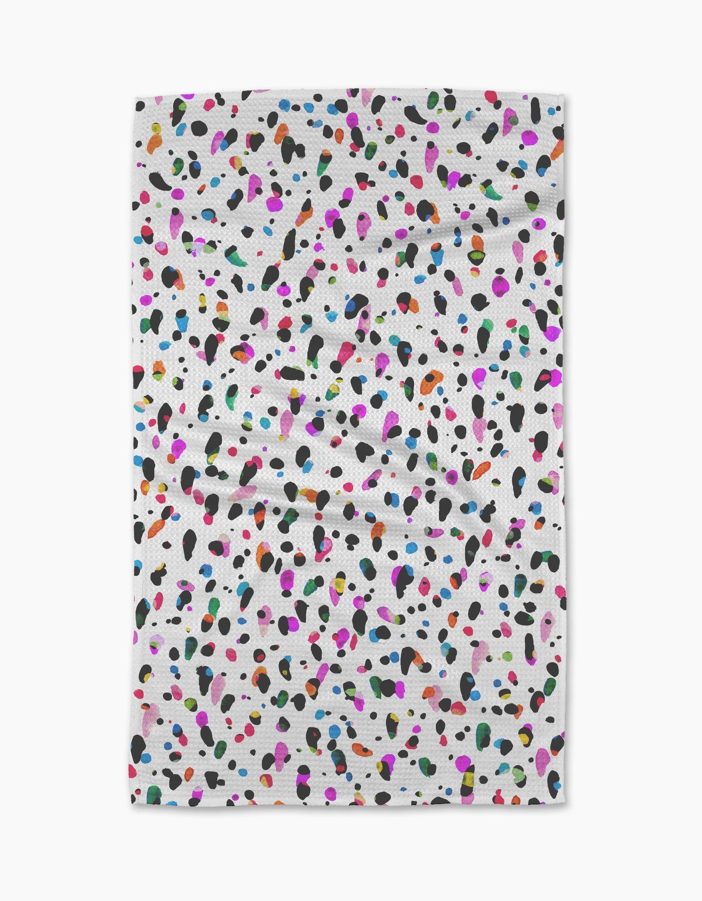 The Spot tea towel by Rachel Parker features a white, ultra-absorbent fabric with scattered black, pink, blue, orange, green, and purple spots. Its plain background highlights the lively pattern on this slightly wrinkled kitchen accessory.