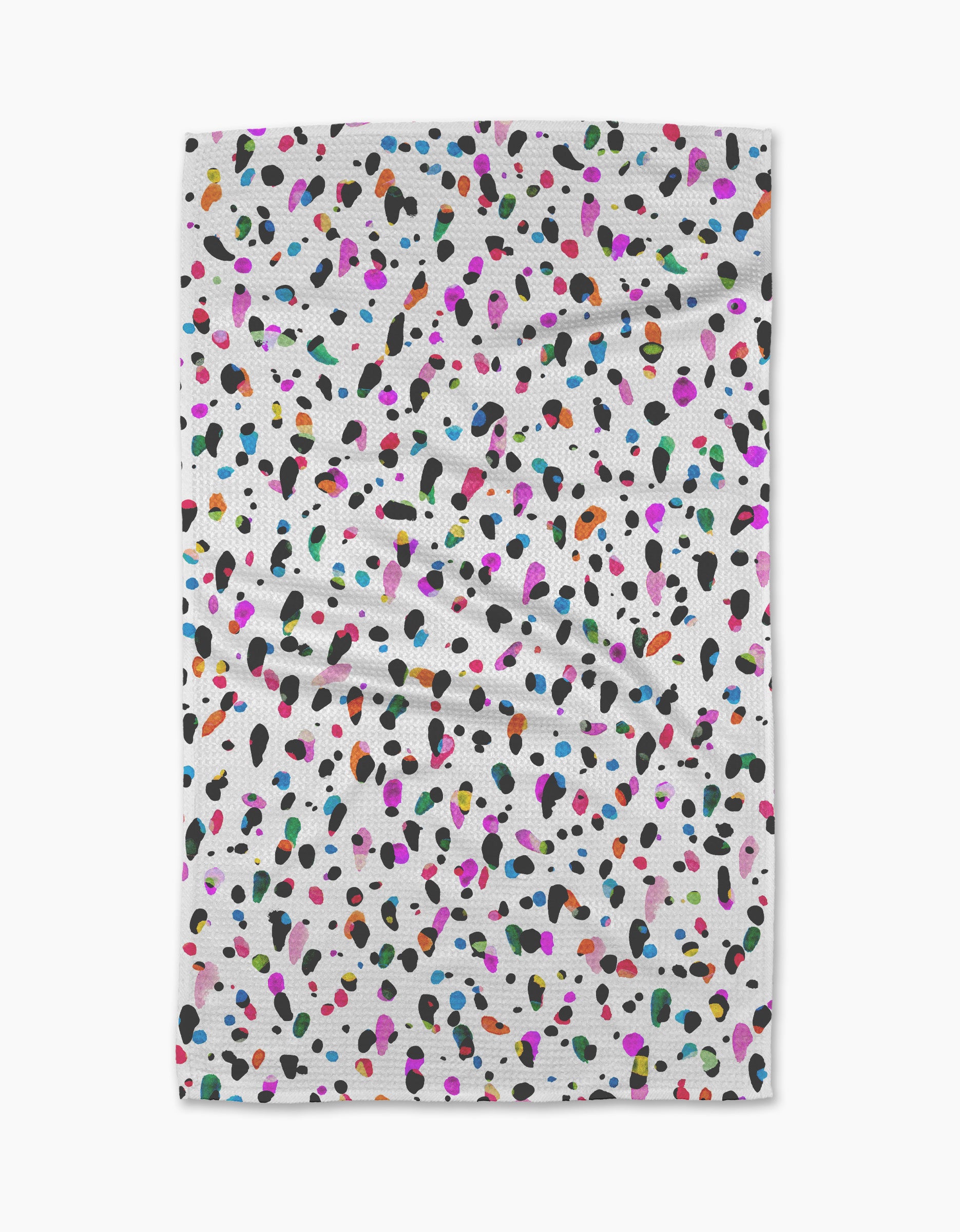 The Spot tea towel by Rachel Parker features a white, ultra-absorbent fabric with scattered black, pink, blue, orange, green, and purple spots. Its plain background highlights the lively pattern on this slightly wrinkled kitchen accessory.